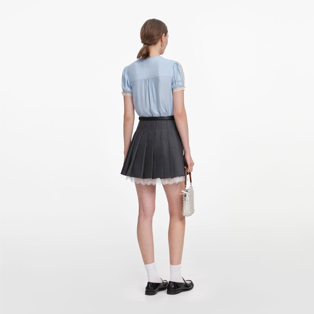 Back view of a woman wearing the Blue Viscose Lace Top