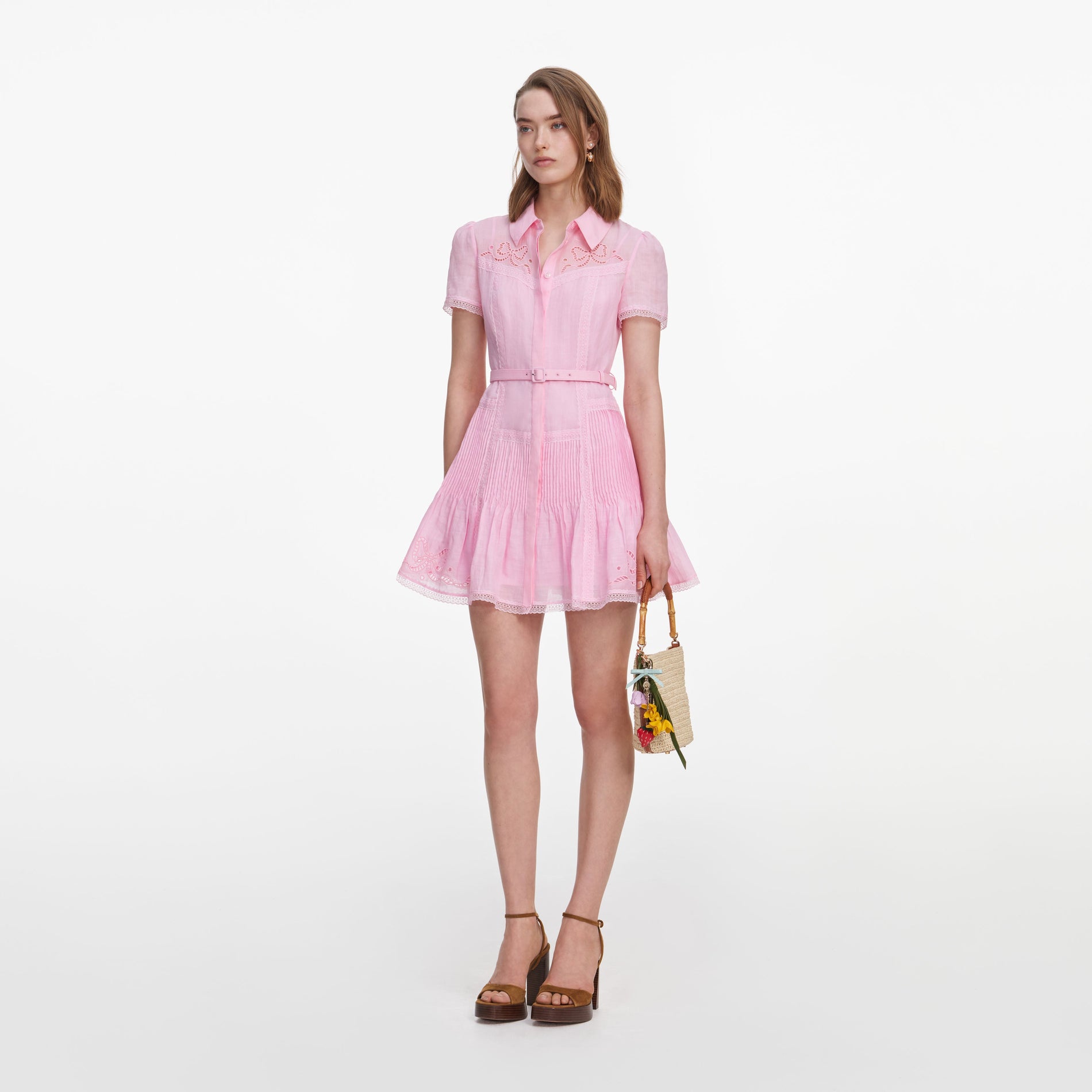 Side view of a woman wearing the Pink Embroidered Mini Dress