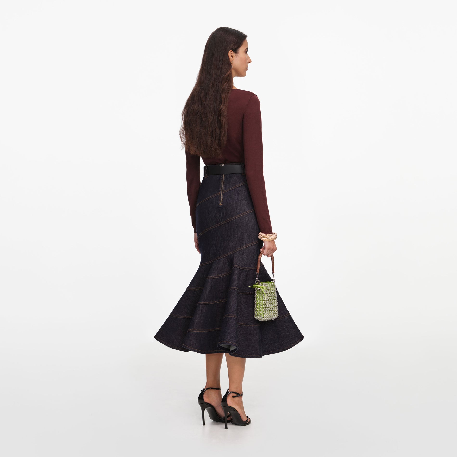 Back view of a woman wearing the Indigo Denim Belted Midi Skirt