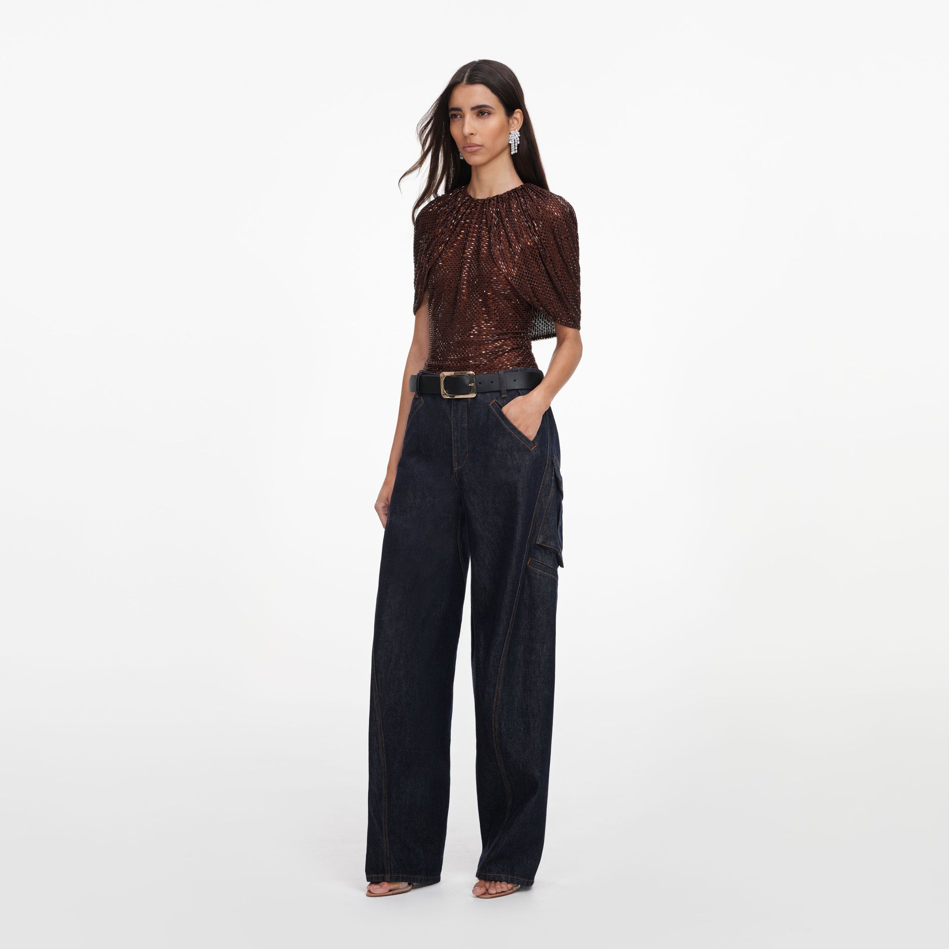 Side view of a woman wearing the Brown Rhinestone Cape Sleeve Top