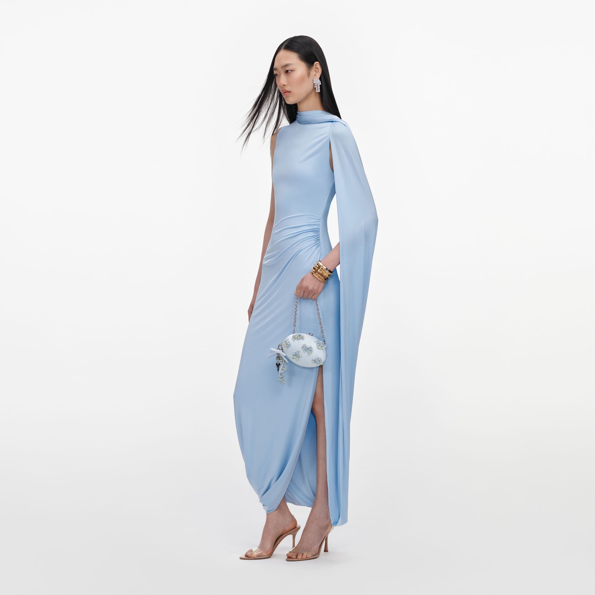 Side view of a woman wearing the Blue Jersey Draped Maxi Dress