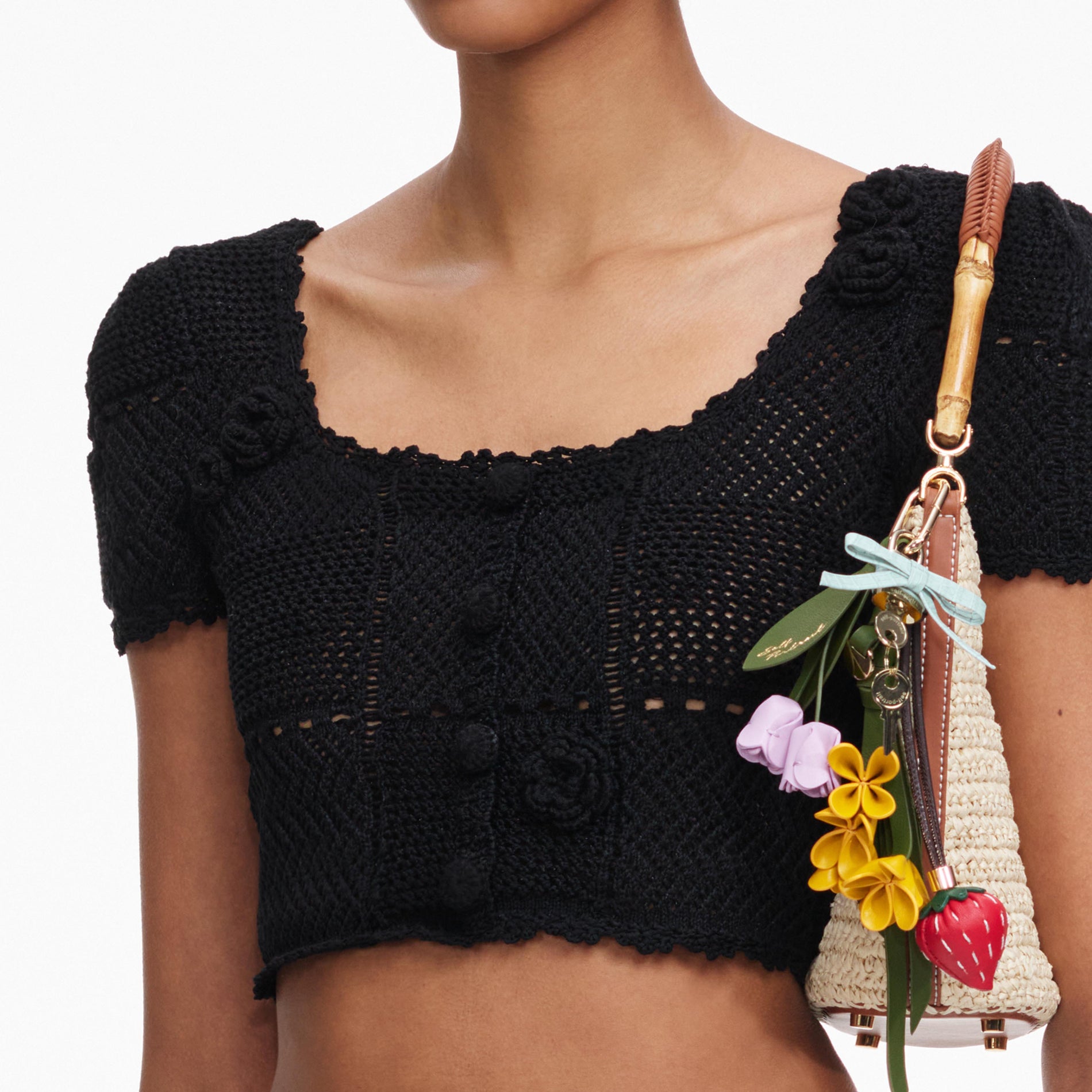A close up of a woman wearing the Black Crochet Knit Crop Top