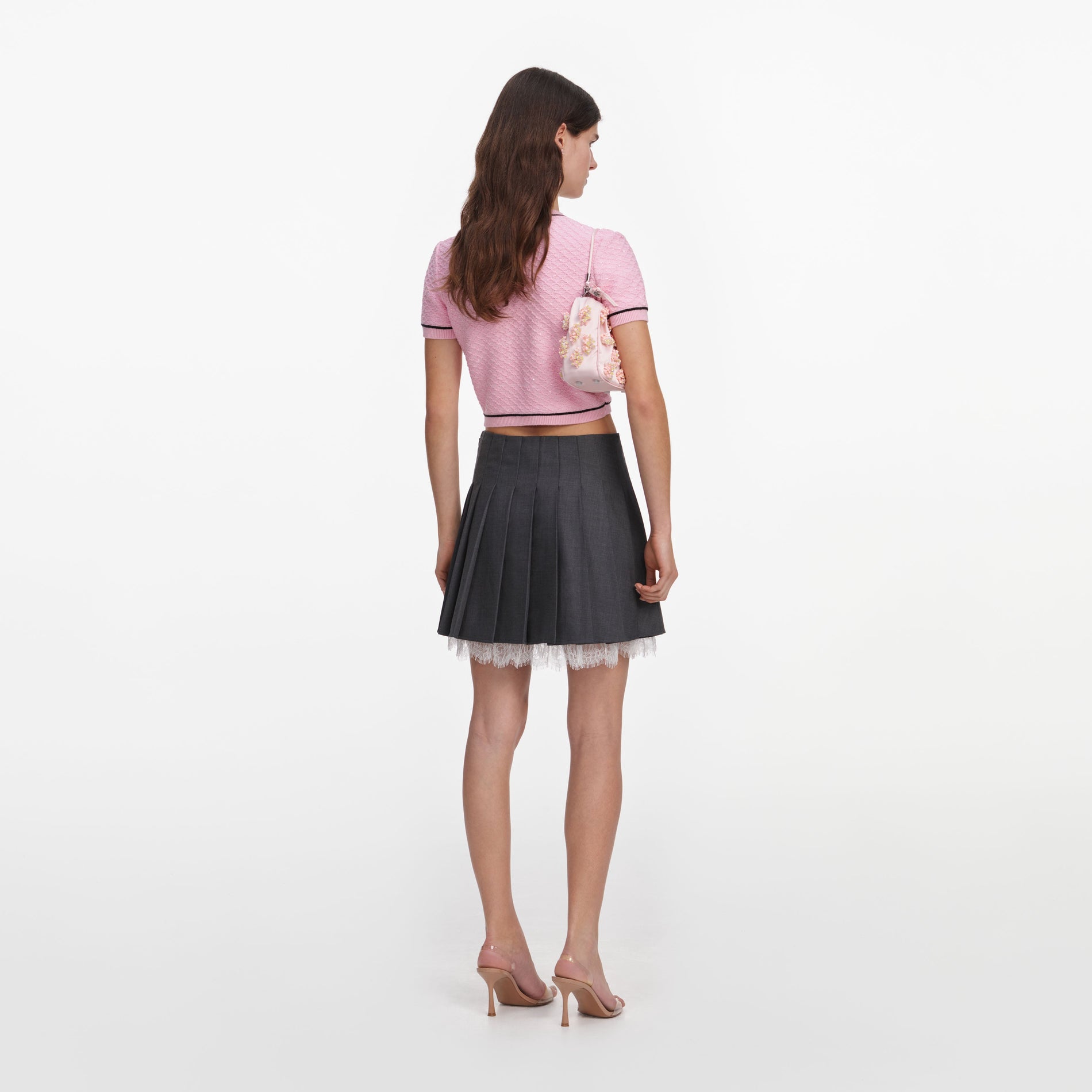 Back view of a woman wearing the Pink Flower Knit Top