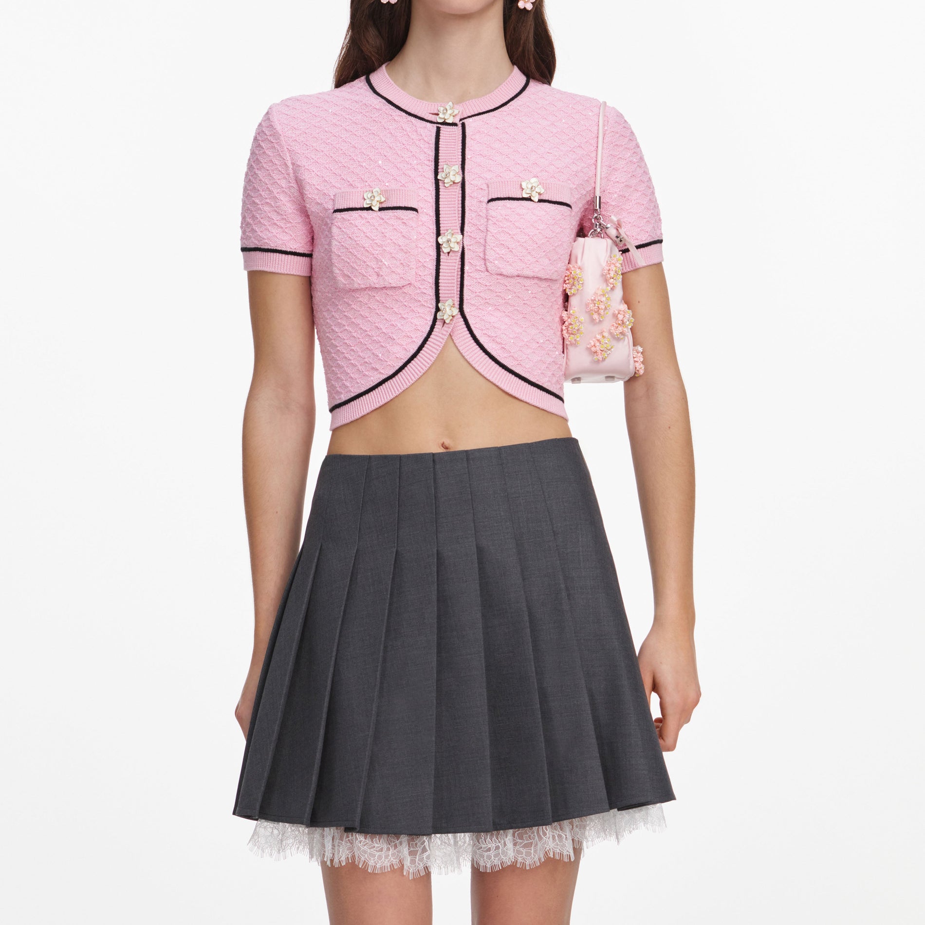 A close up of a woman wearing the Pink Flower Knit Top