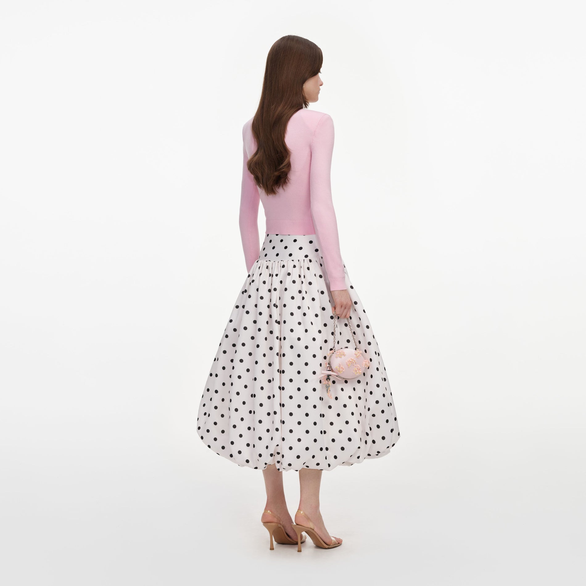 Back view of a woman wearing the Cream Polka Dot Taffeta Midi Skirt