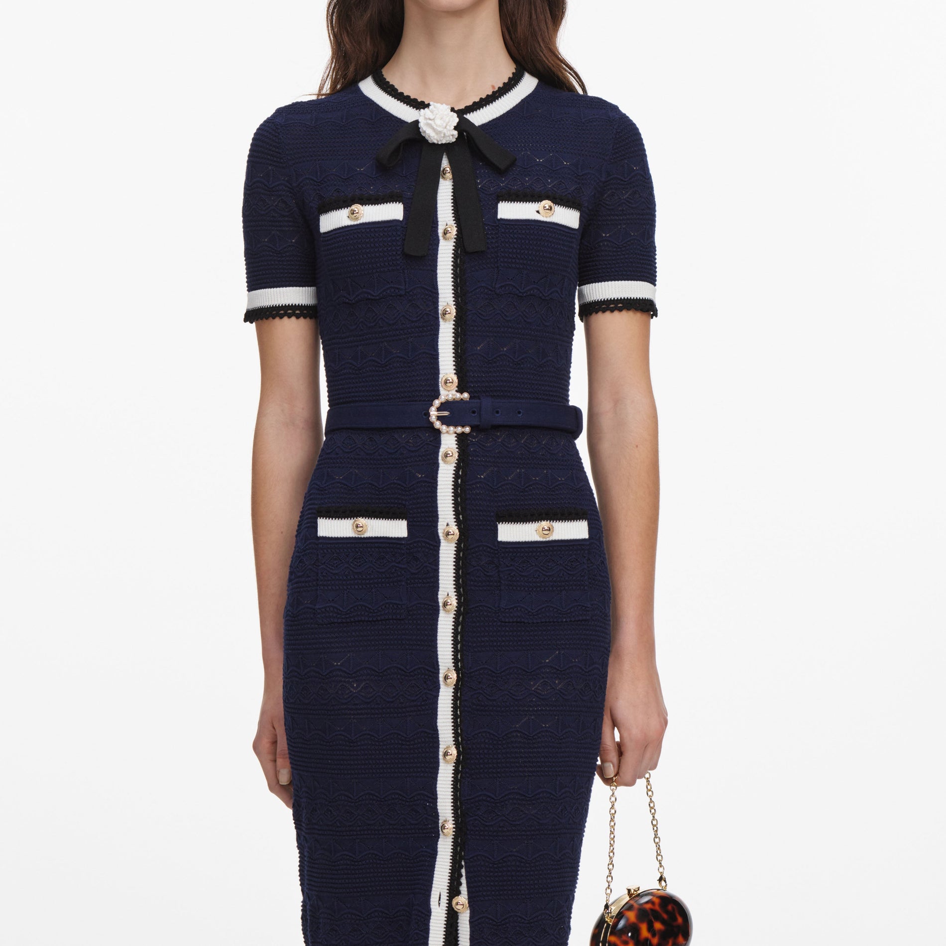 A close up of a woman wearing the Navy Pointelle Knit Midi Dress