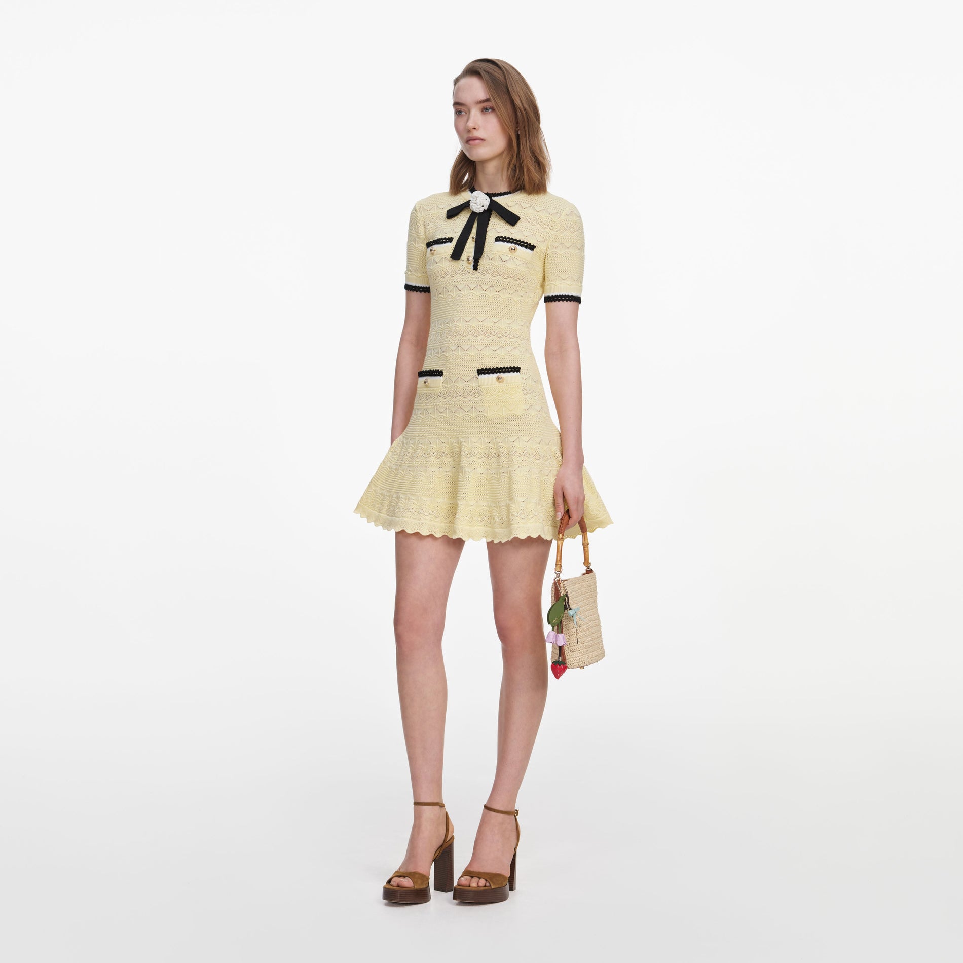 Side view of a woman wearing the Yellow Pointelle Knit Mini Dress