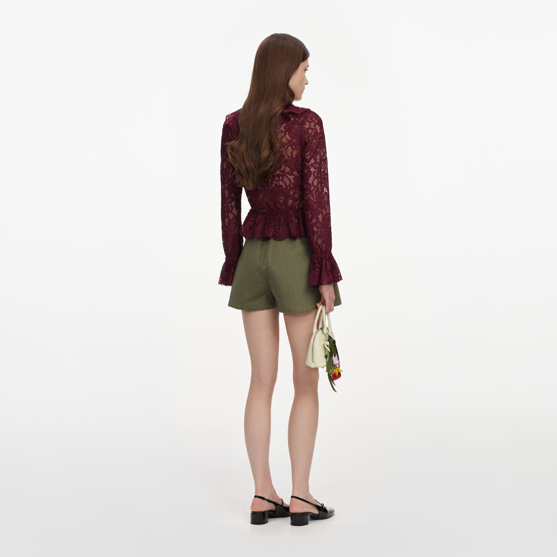 Back view of a woman wearing the Plum Lace Ruffle Top