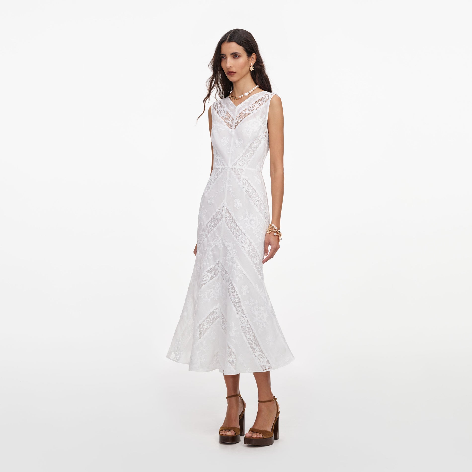 Side view of a woman wearing the White Ramie Sleeveless Midi Dress