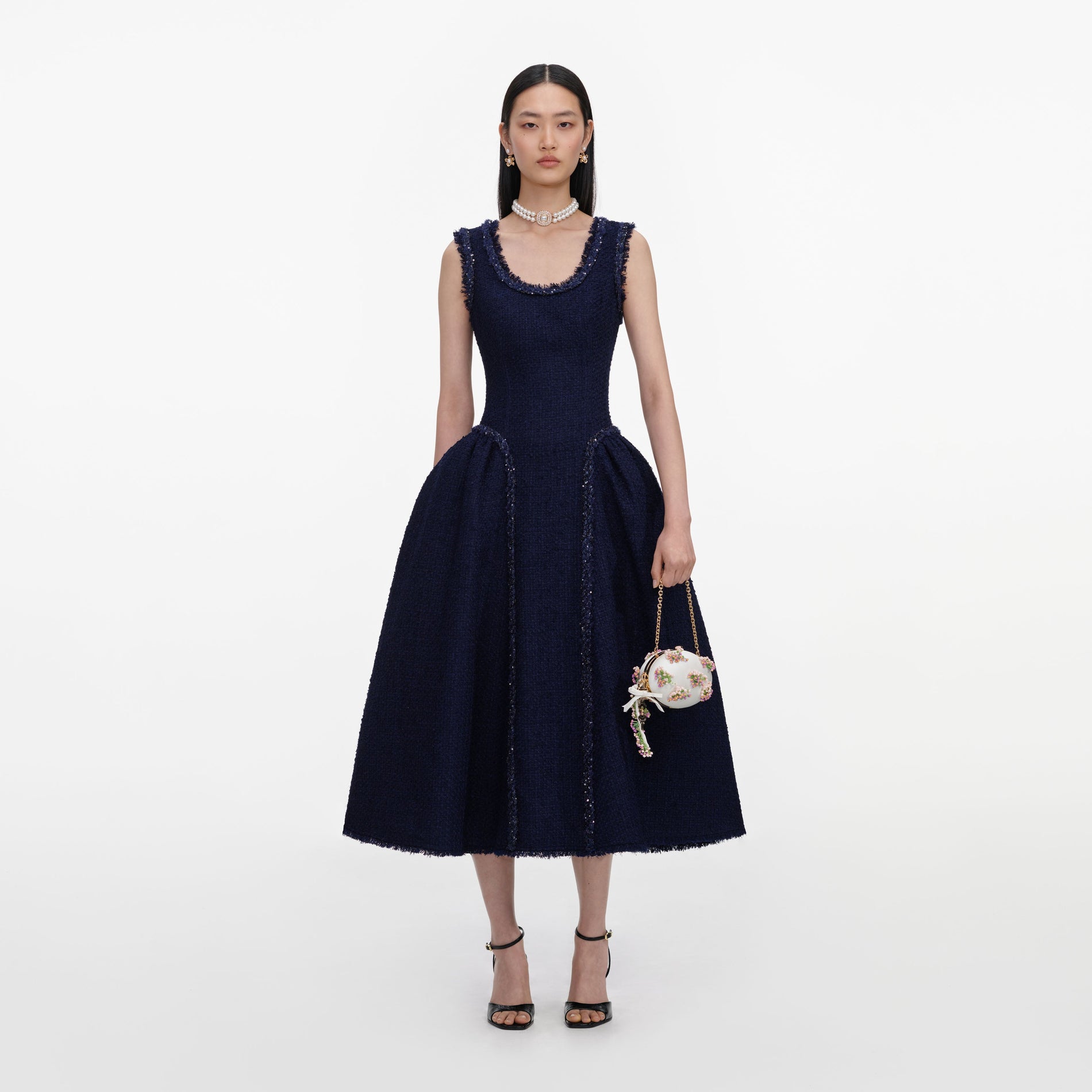 Front view of a woman wearing the Navy Boucle Midi Dress