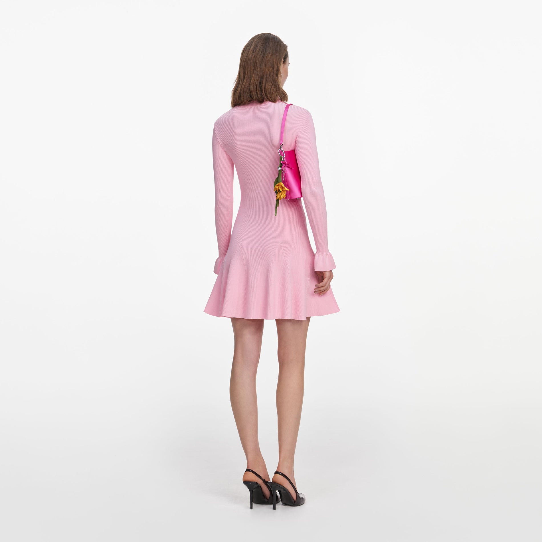 Back view of a woman wearing the Pink Viscose Knit Tie Mini Dress