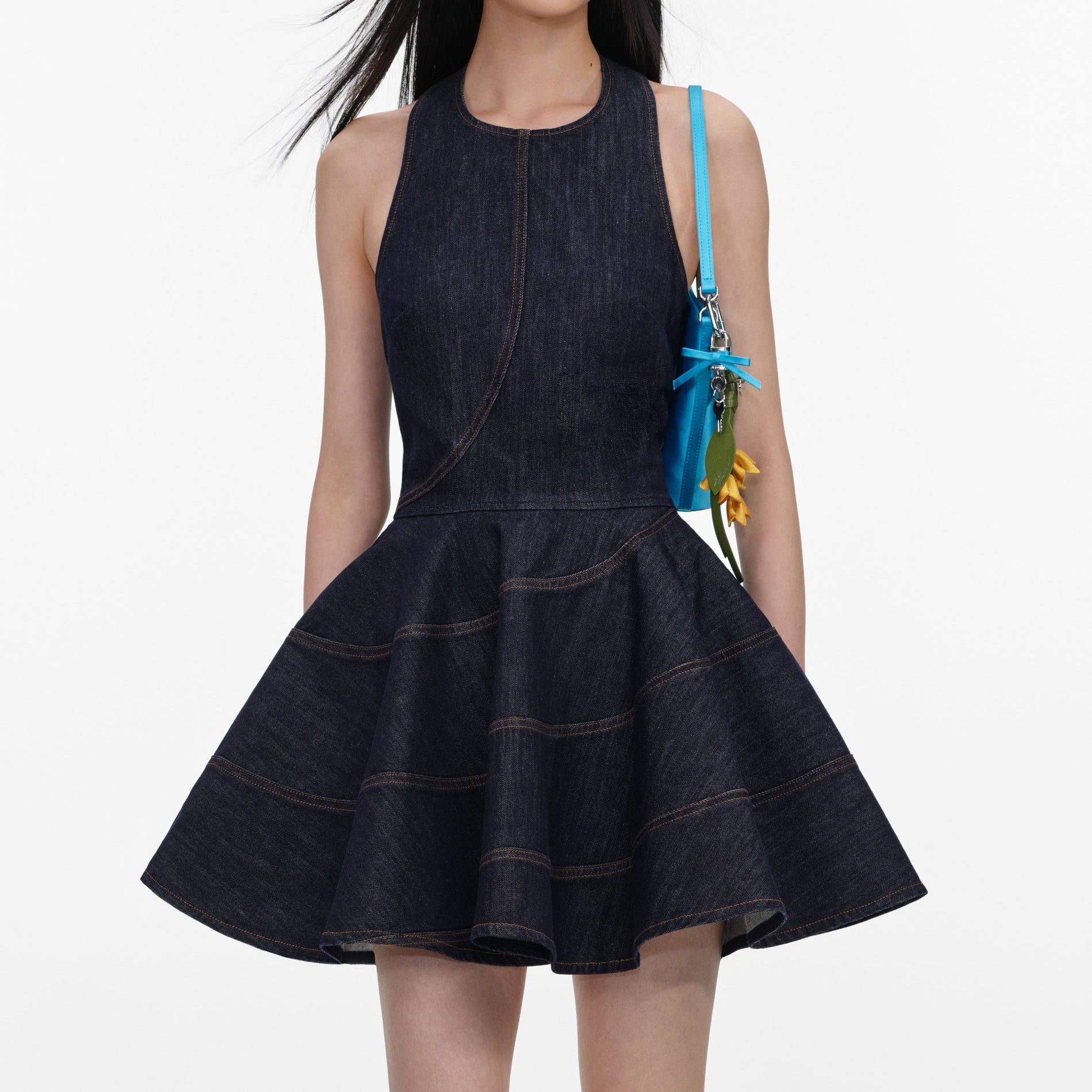 A close up of a woman wearing the Indigo Denim Halterneck Mini Dress