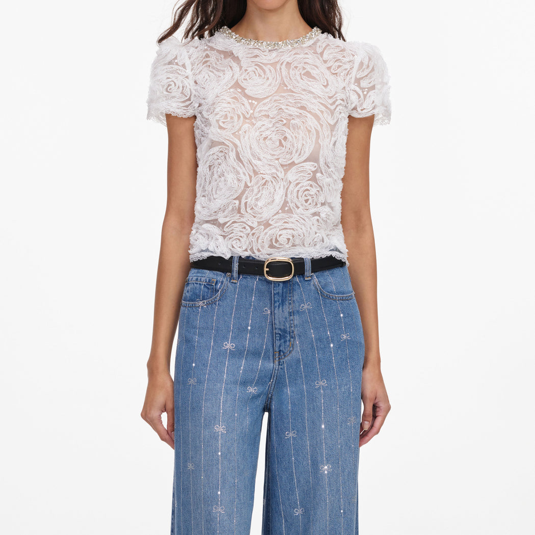 A close up of a woman wearing the Light Blue Rhinestone Stripe Denim Jeans