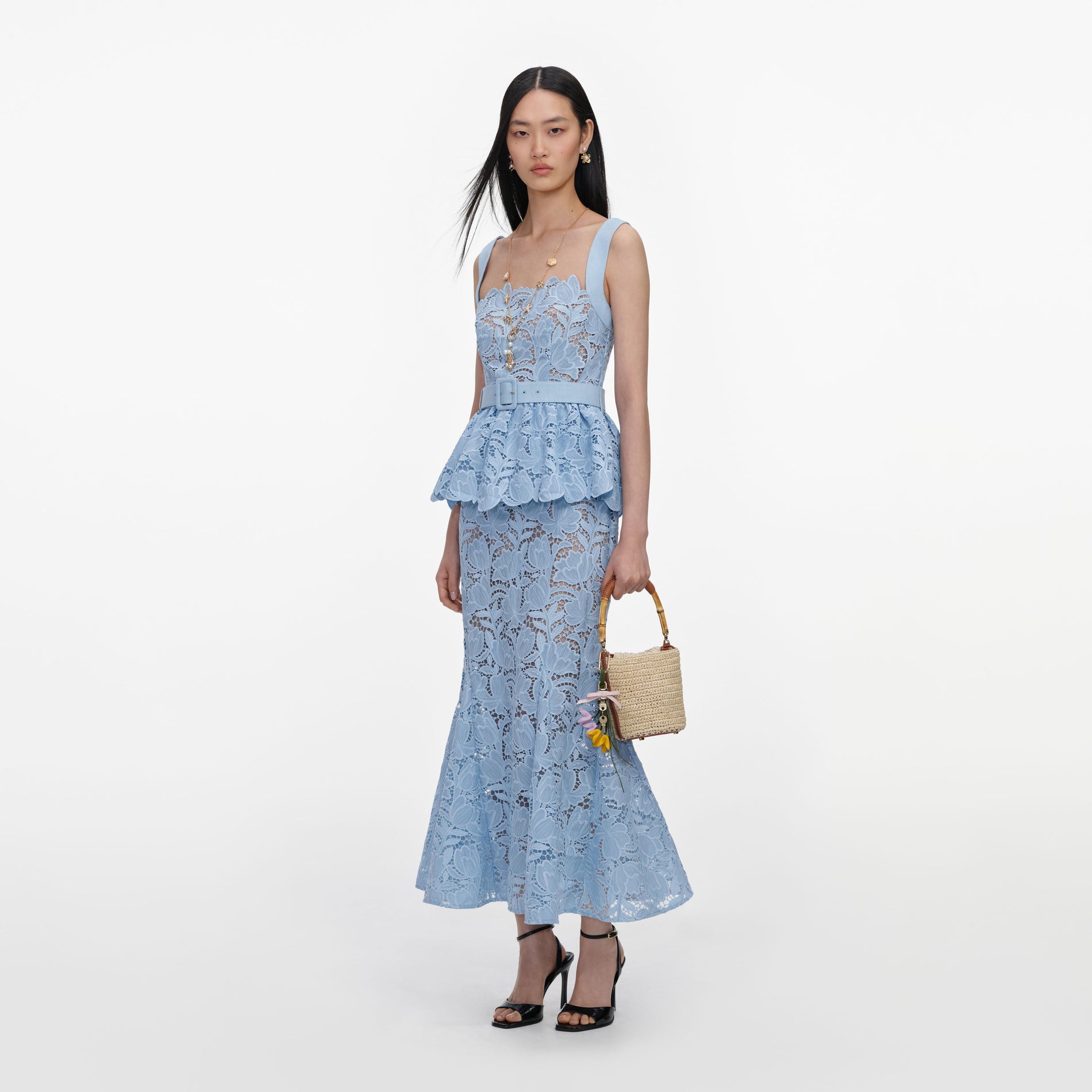 Side view of a woman wearing the Blue Lace Peplum Midi Dress