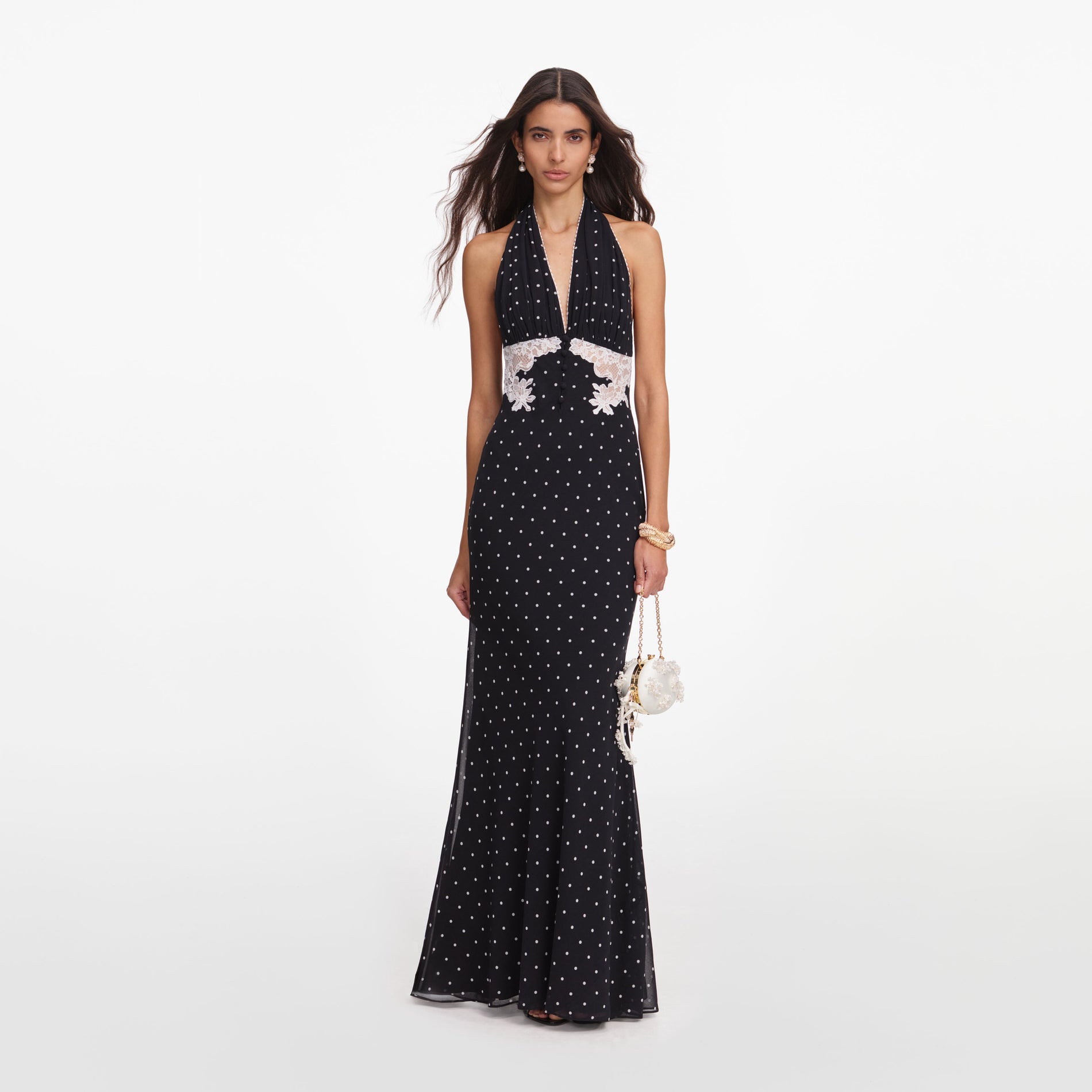 Front view of a woman wearing the Black Polka Dot Halter Neck Maxi Dress
