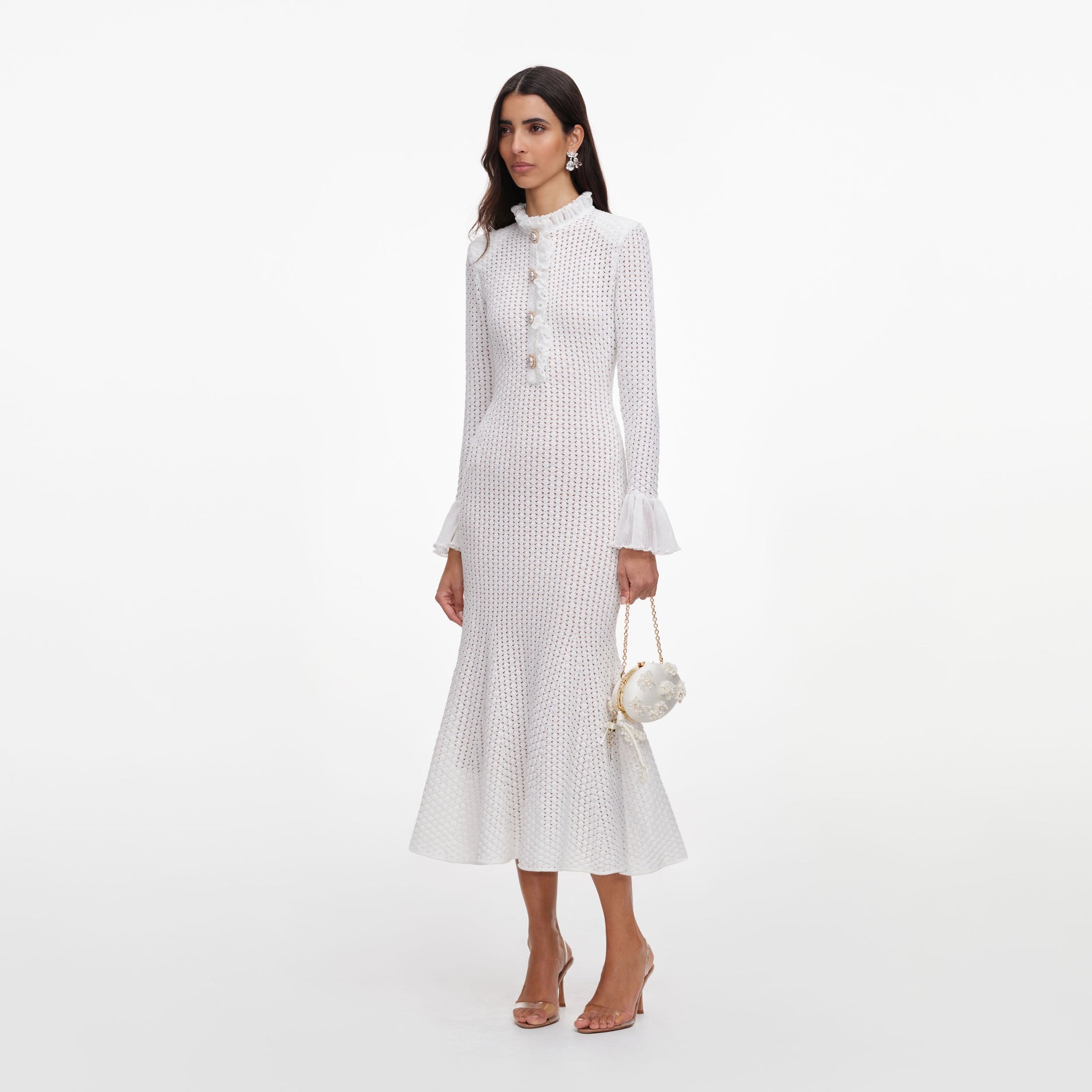 Side view of a woman wearing the White Pointelle Knit Flare Midi Dress
