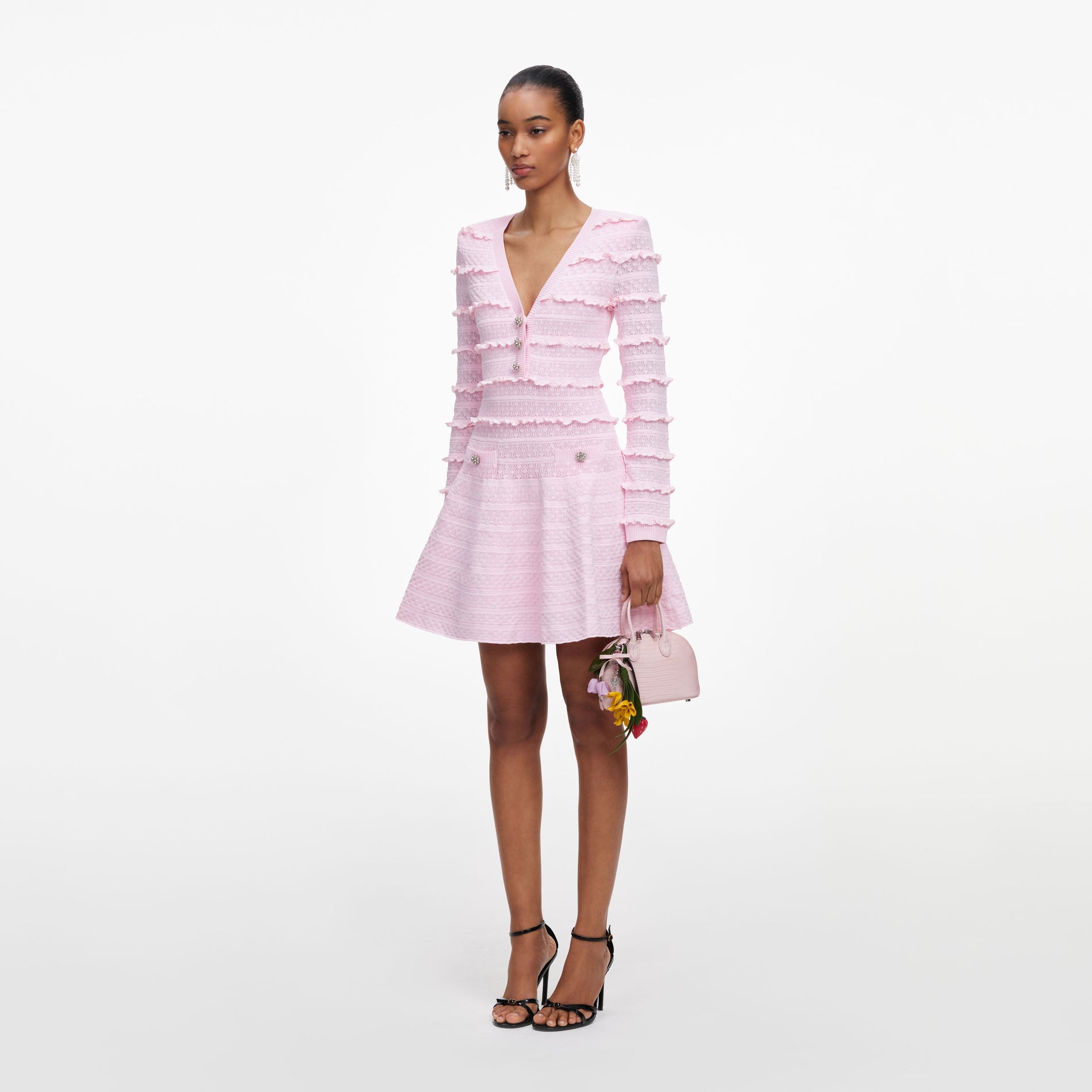 Side view of a woman wearing the Pink Pointelle Diamante Knit Mini Dress