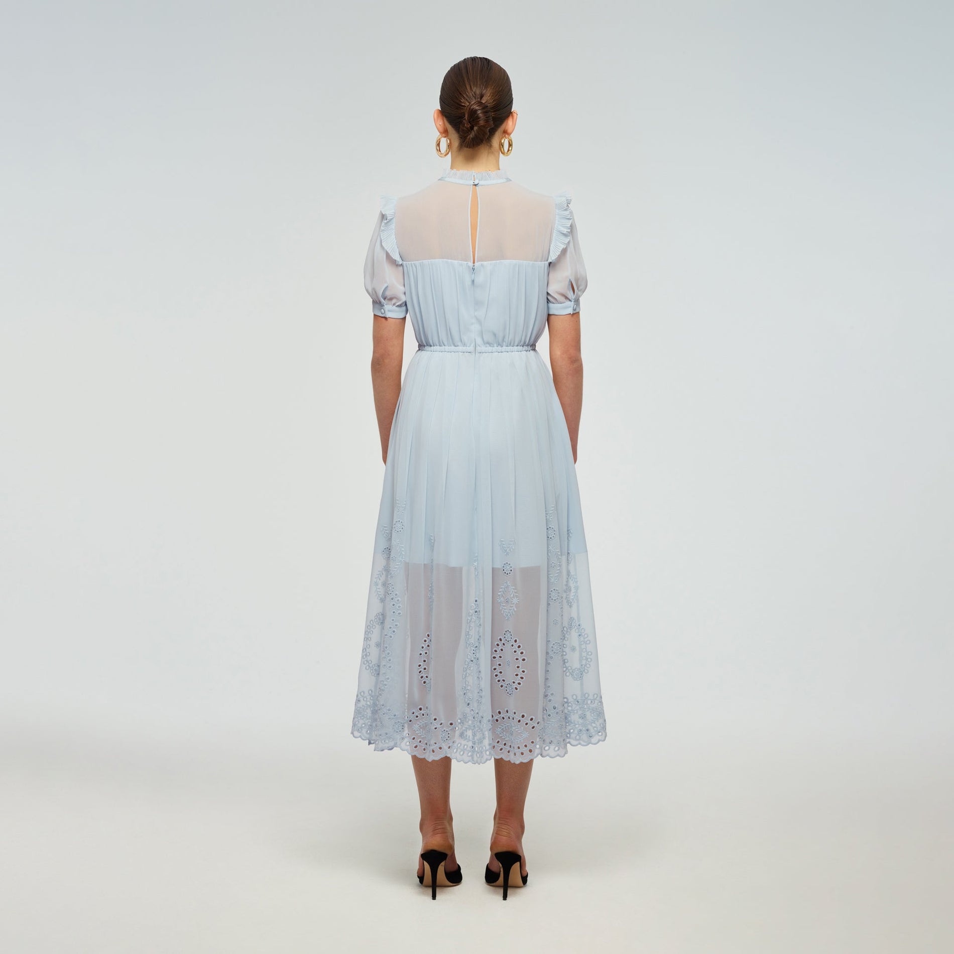 A woman wearing the Blue Broderie Chiffon Dress