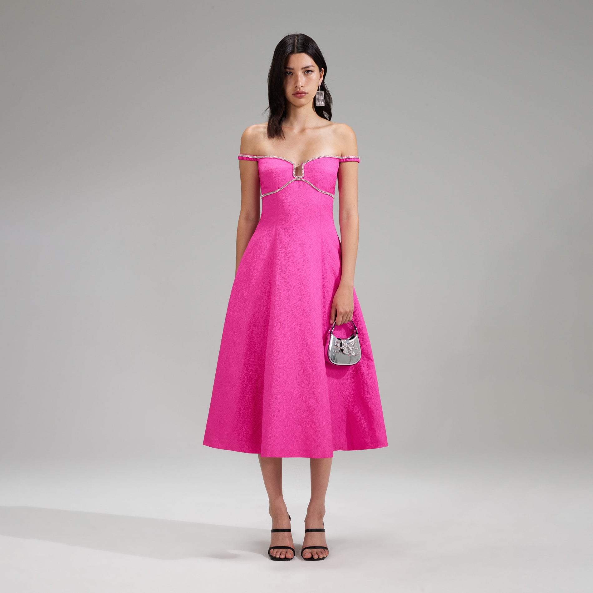 A woman wearing the Pink Textured Diamante Detail Midi Dress