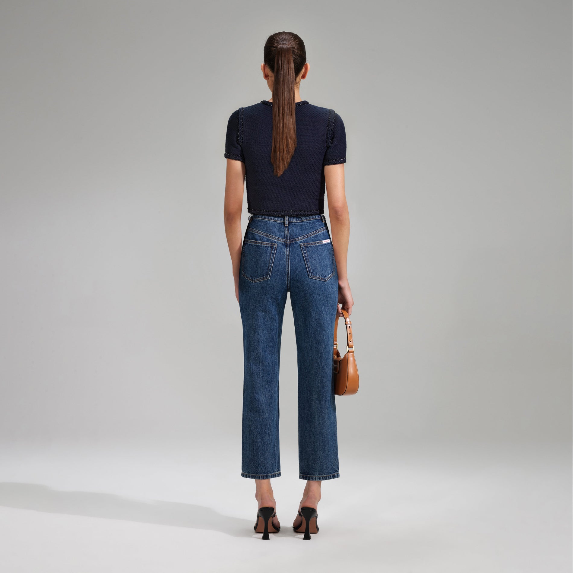 A woman wearing the Navy Knit Crop Cardigan