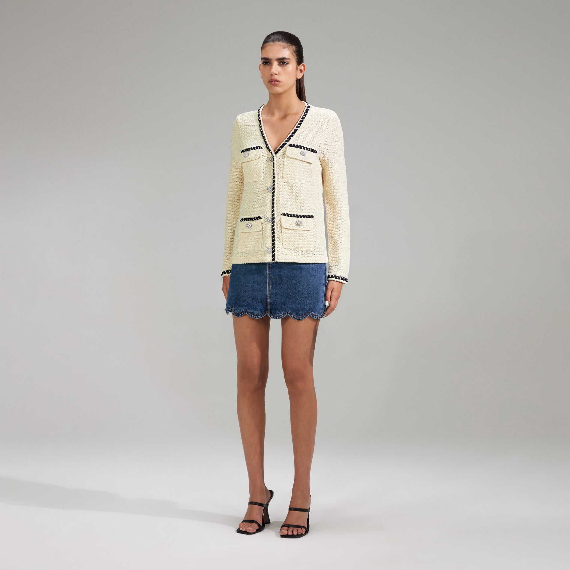 A woman wearing the Cream Sequin Knitted Cardigan