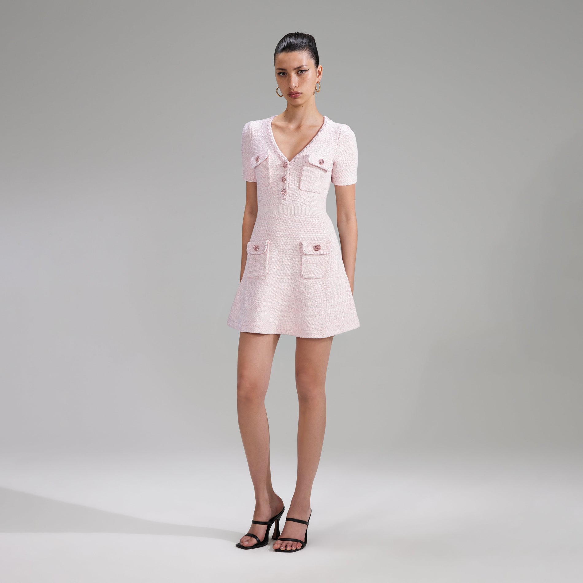 A woman wearing the Pink Cotton Knit Mini Dress