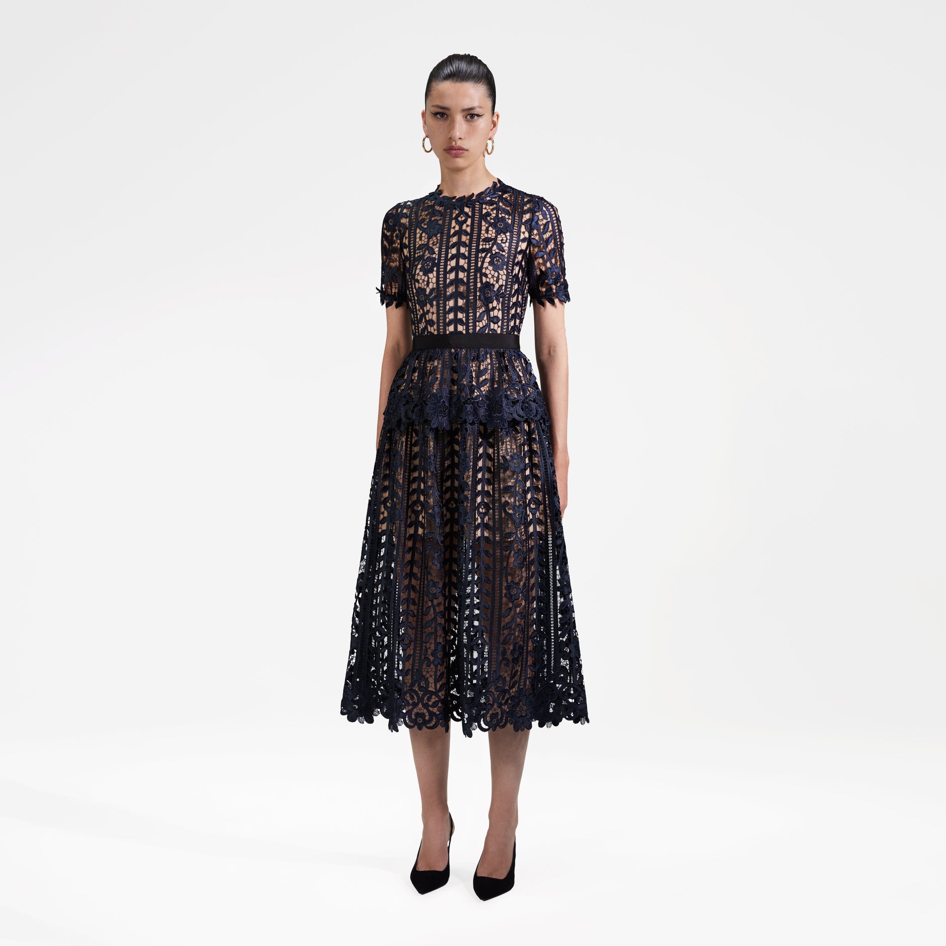 Side view of a woman wearing the Navy Lace Midi Dress