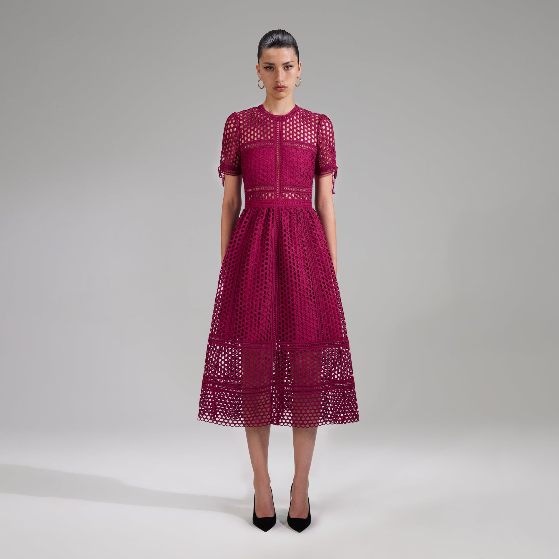 A woman wearing the Burgundy Lace Midi Dress