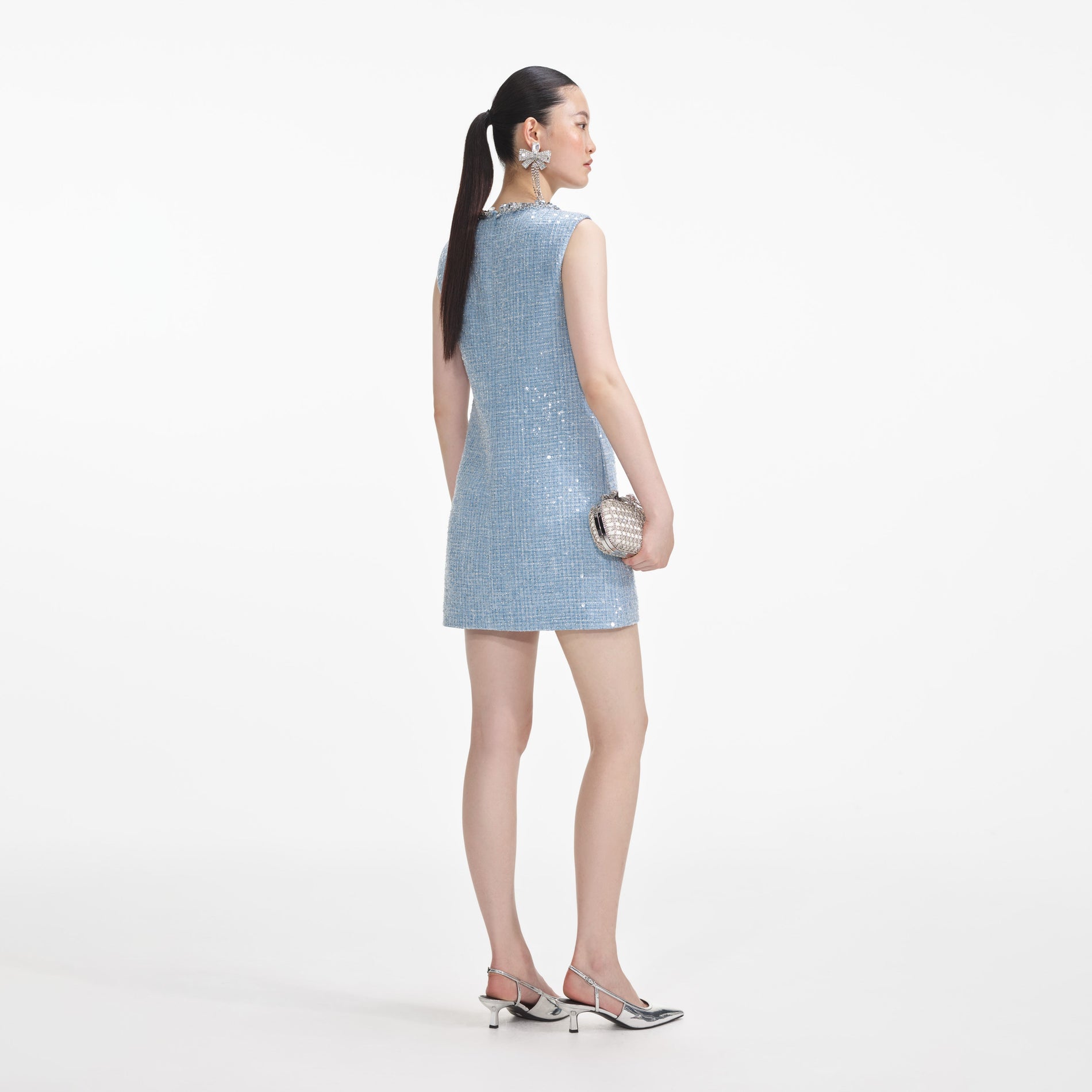 Back view of a woman wearing the Blue Sequin Boucle Mini Dress