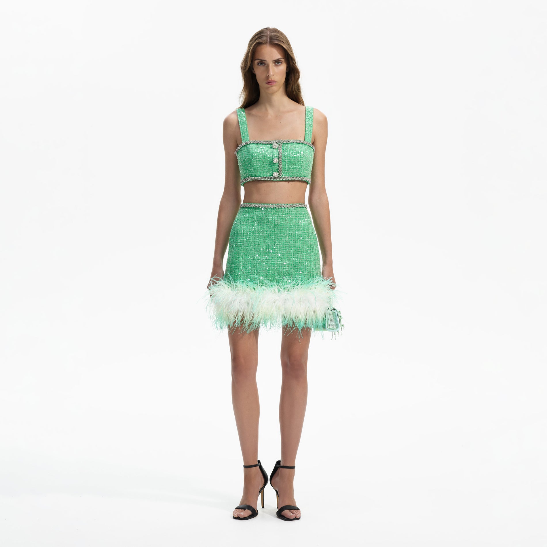 Front view of a woman wearing the Green Boucle Feather Mini Skirt