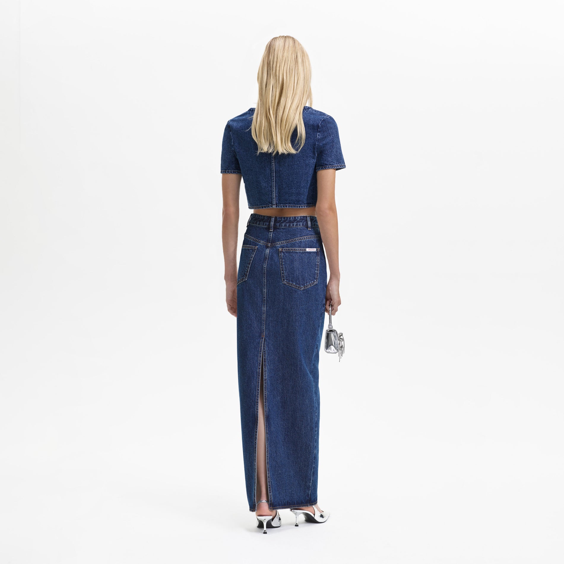 Back view of a woman wearing the Denim Stitch Detail Top