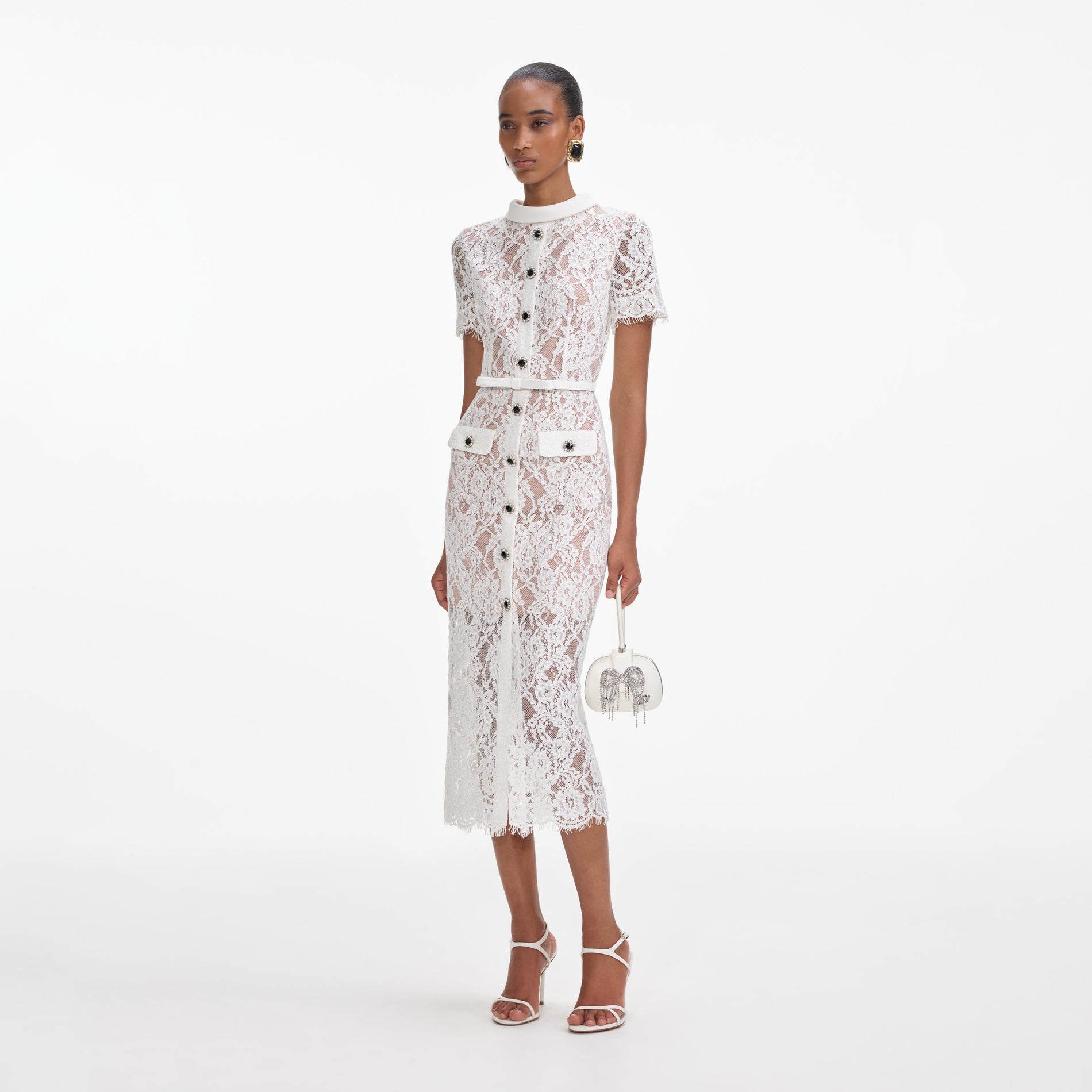 Side view of a woman wearing the White Lace Button Midi Dress
