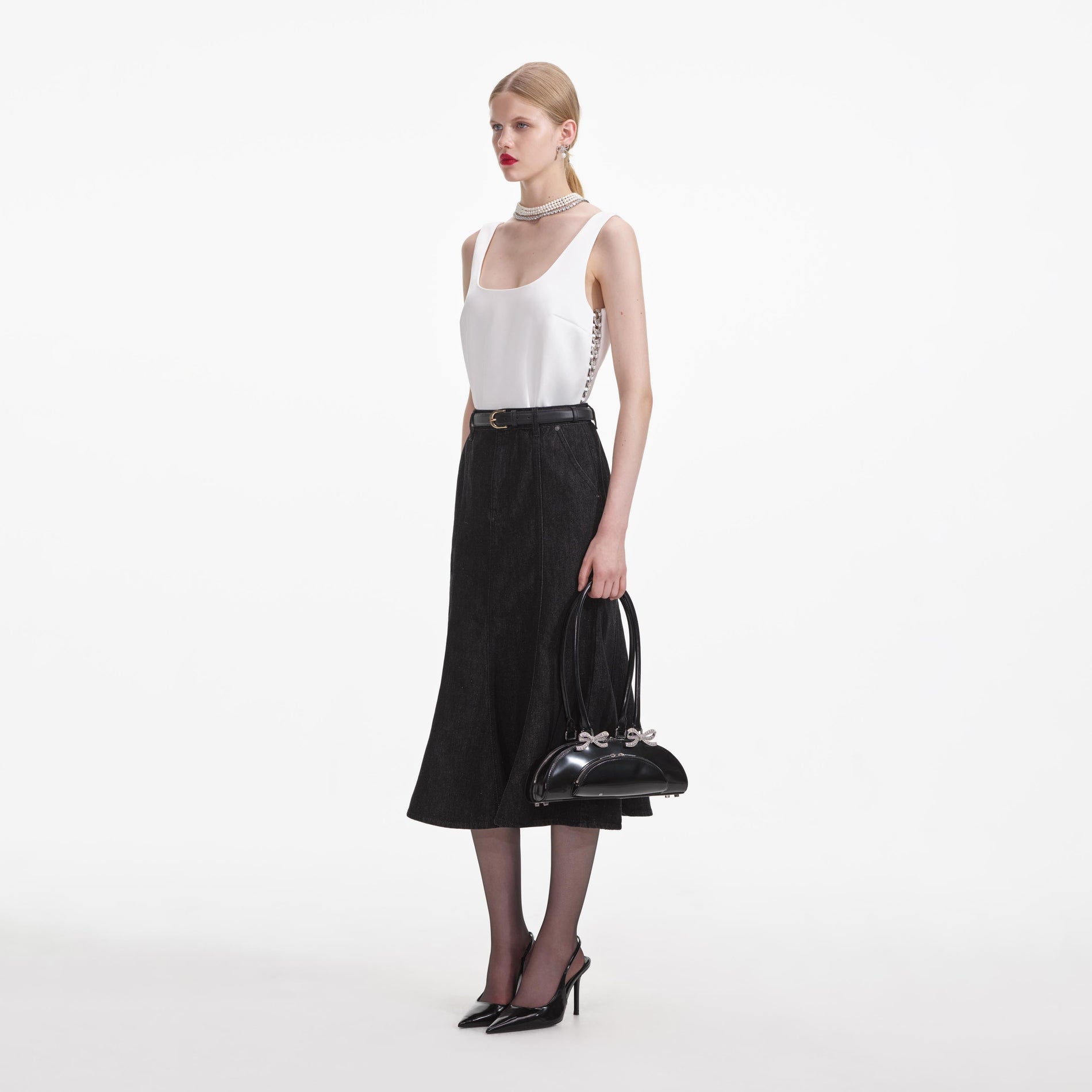 Side view of a woman wearing the White Bonded Satin Vest