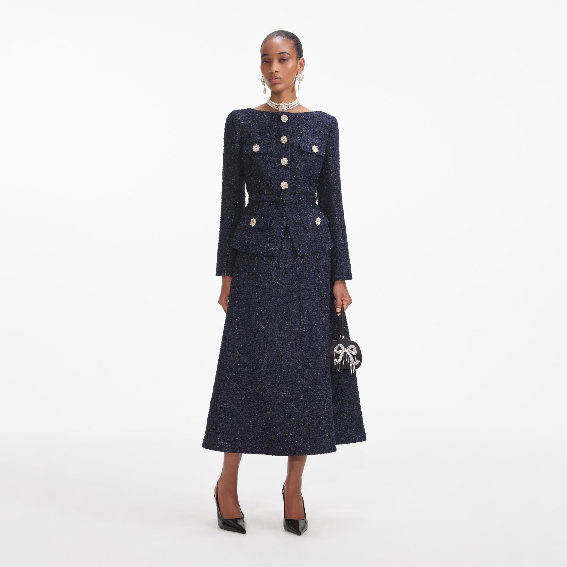 A close up of a woman wearing the Navy Metallic Boucle Midi Dress