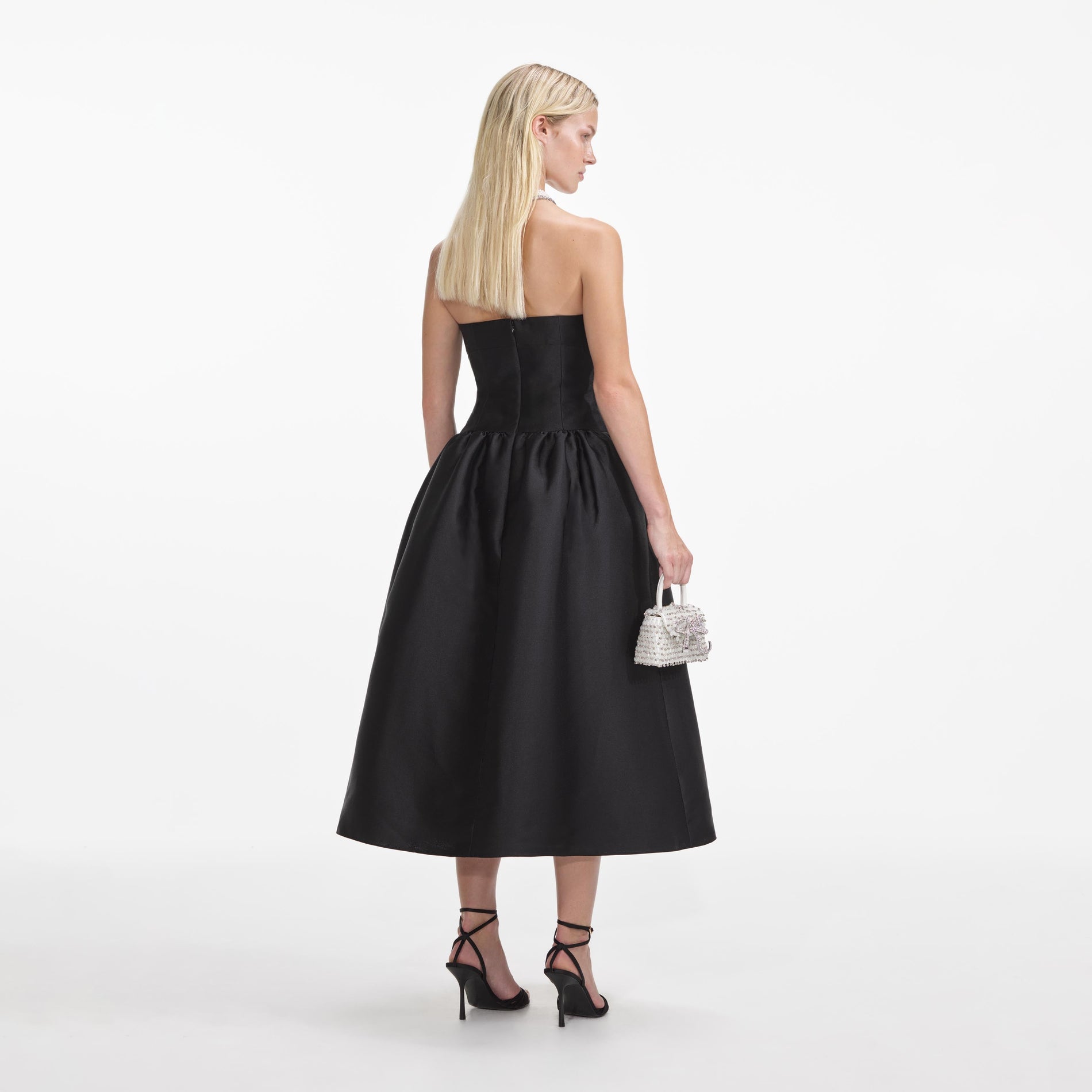 Back view of a woman wearing the Black Taffeta Contrast Bow Midi Dress