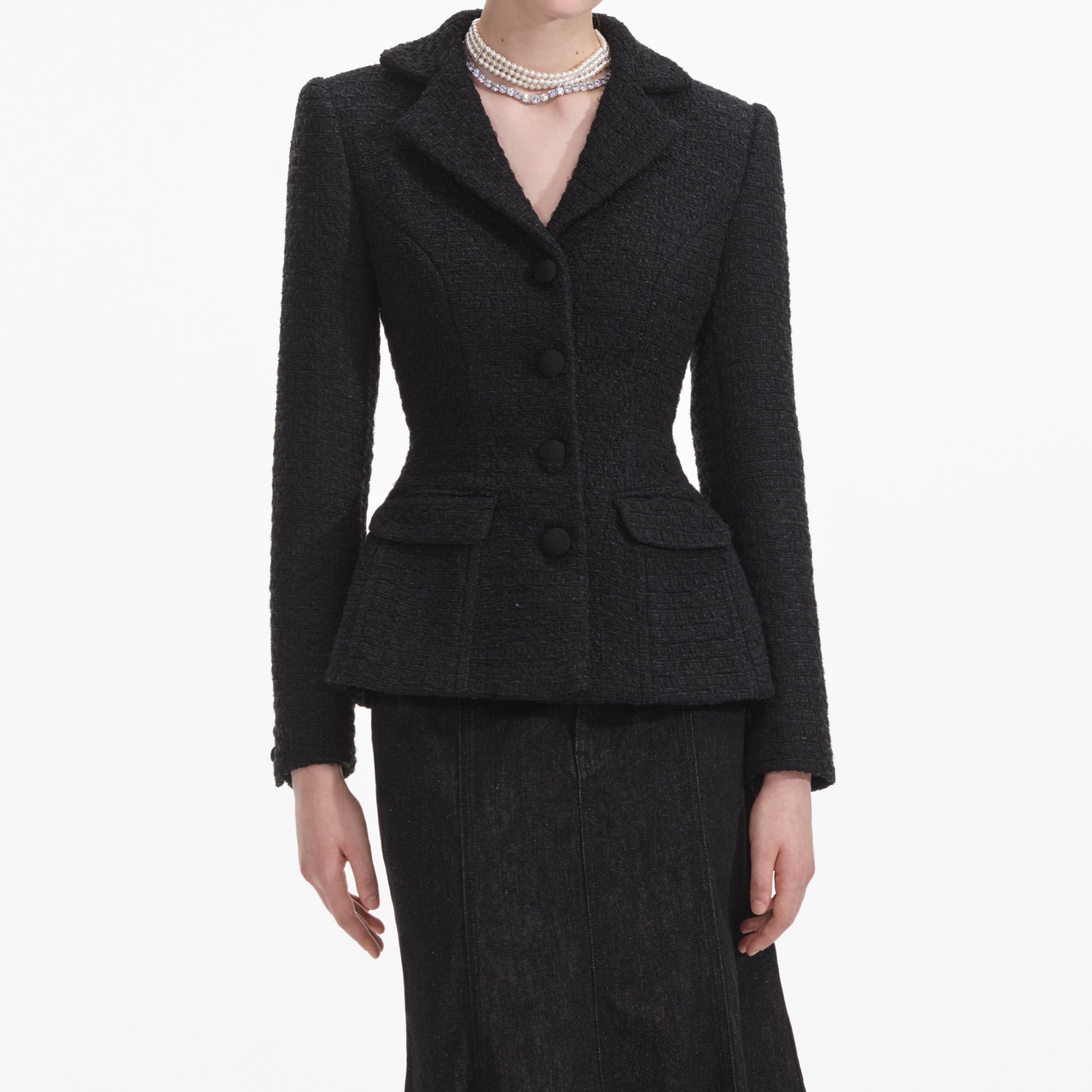 A close up of a woman wearing the Black Boucle Jacket