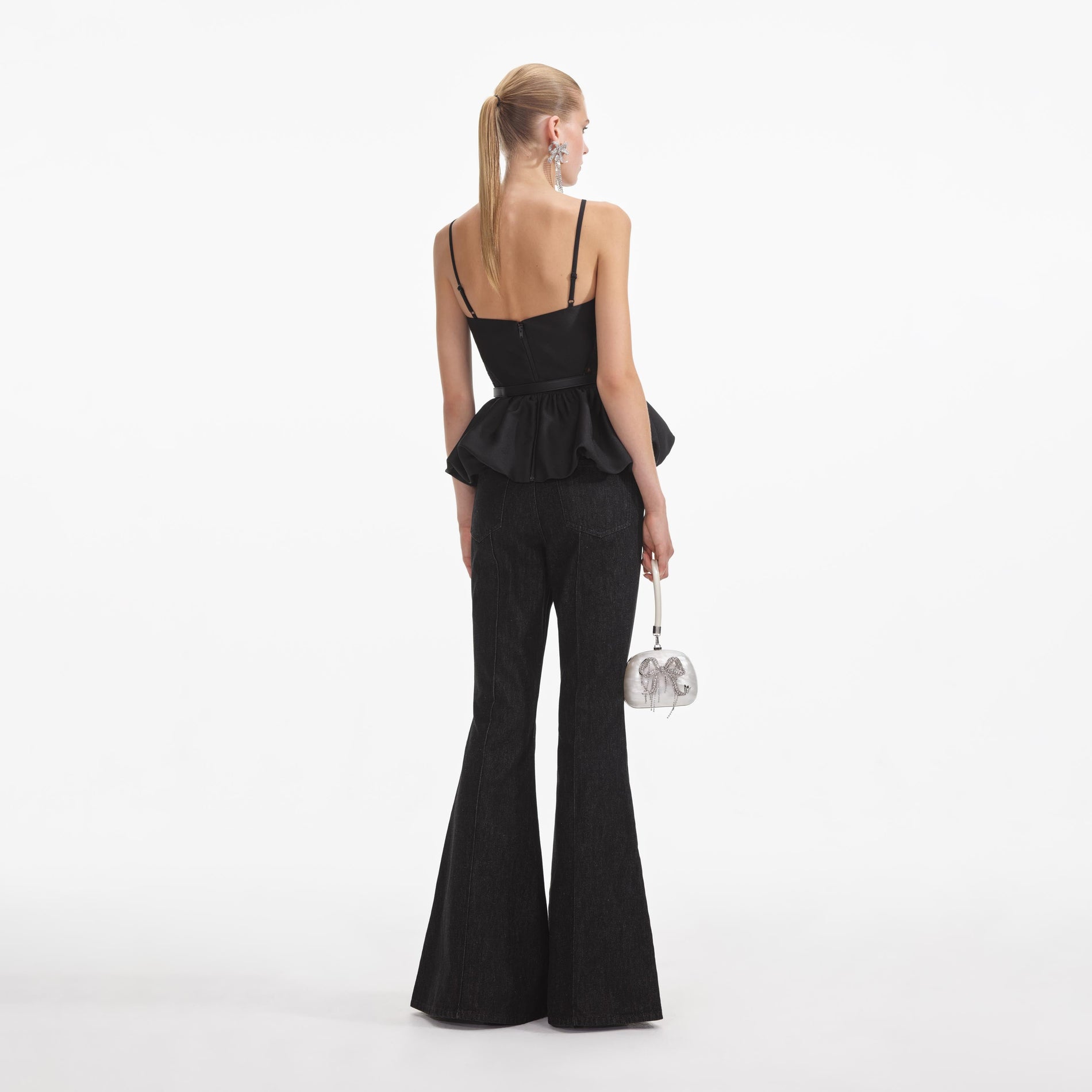 Back view of a woman wearing the Black Taffeta Peplum Top