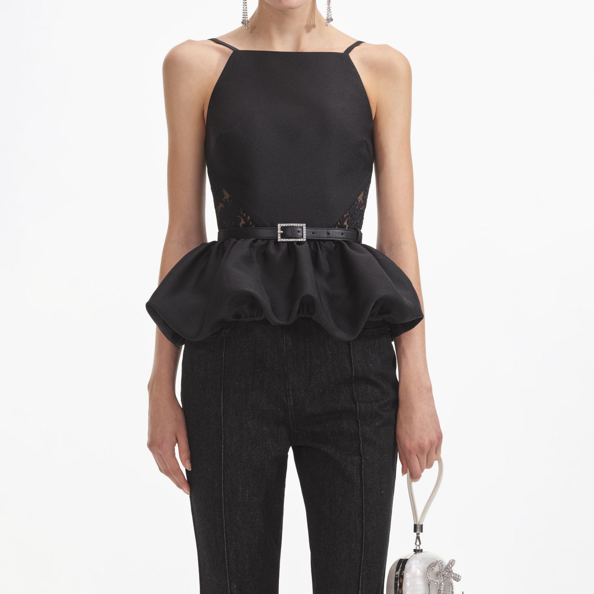 A close up of a woman wearing the Black Taffeta Peplum Top