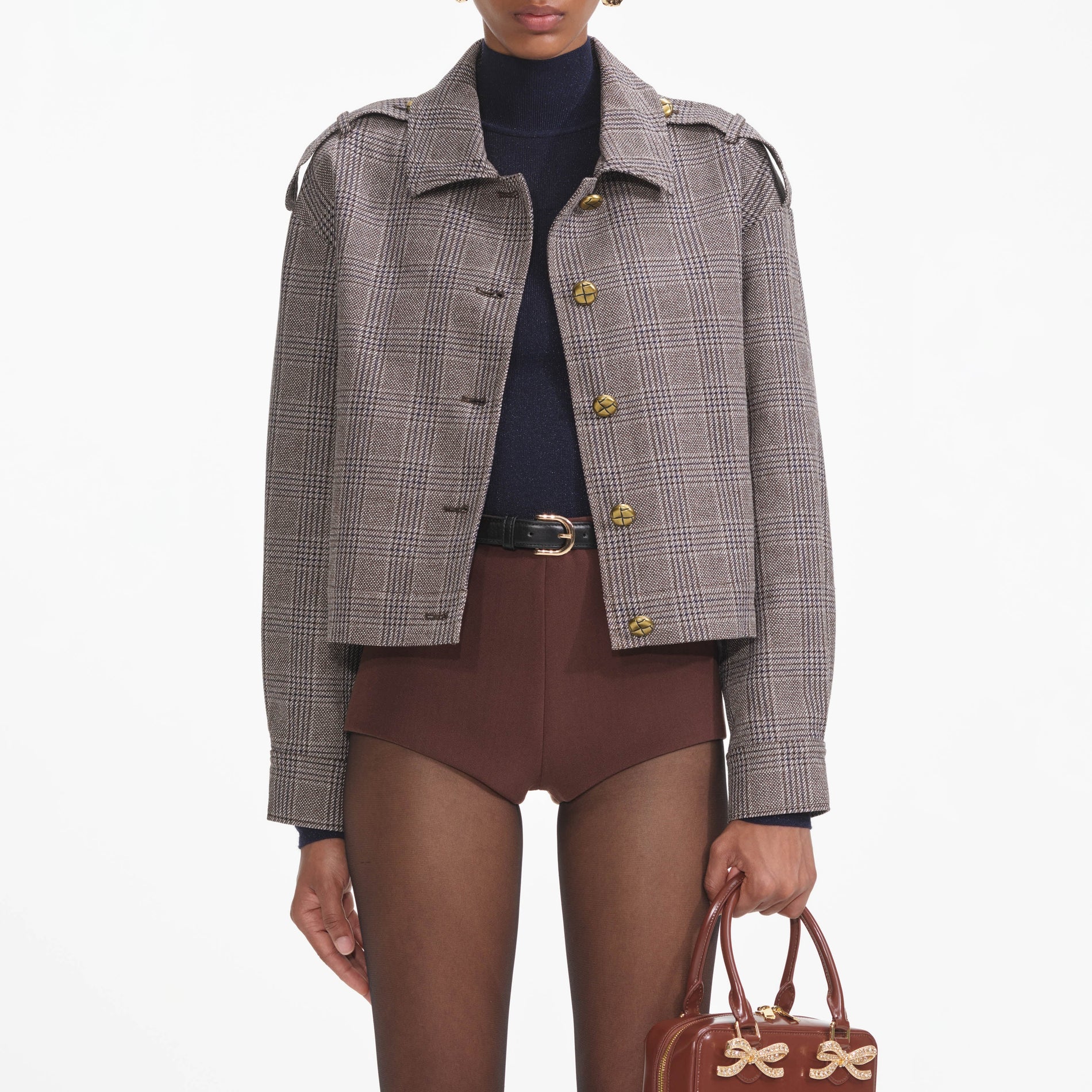 A close up of a woman wearing the Brown Check Jacket