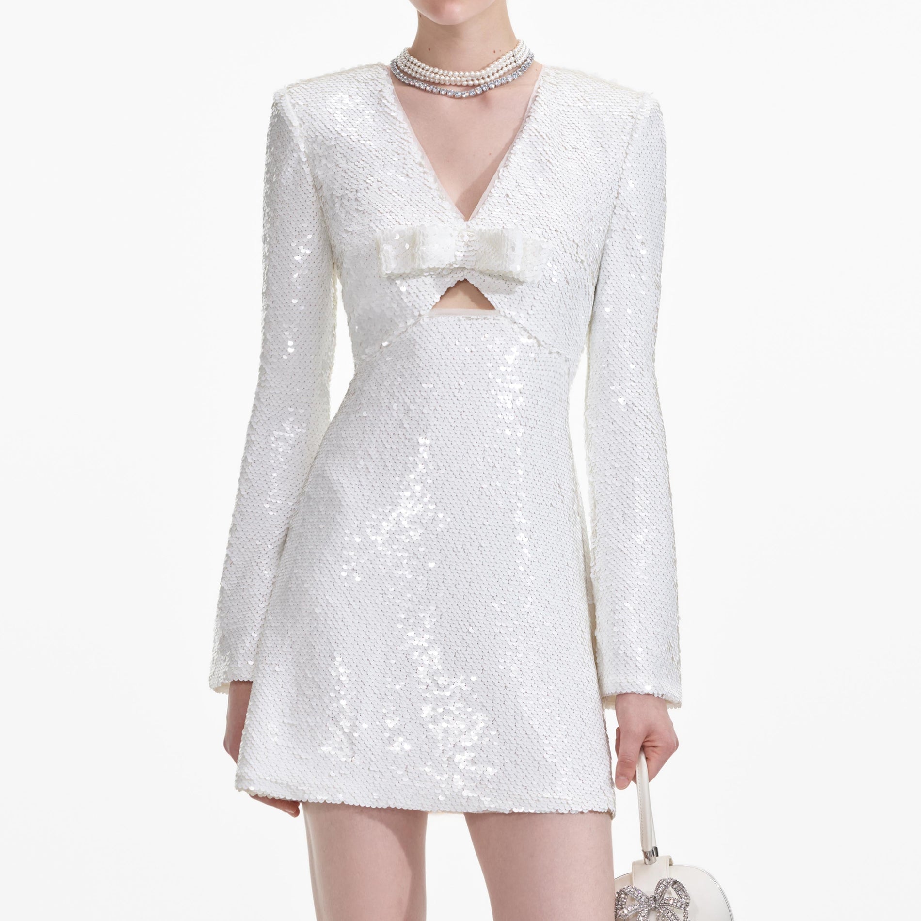 A close up of a woman wearing the White Sequin Mini Dress