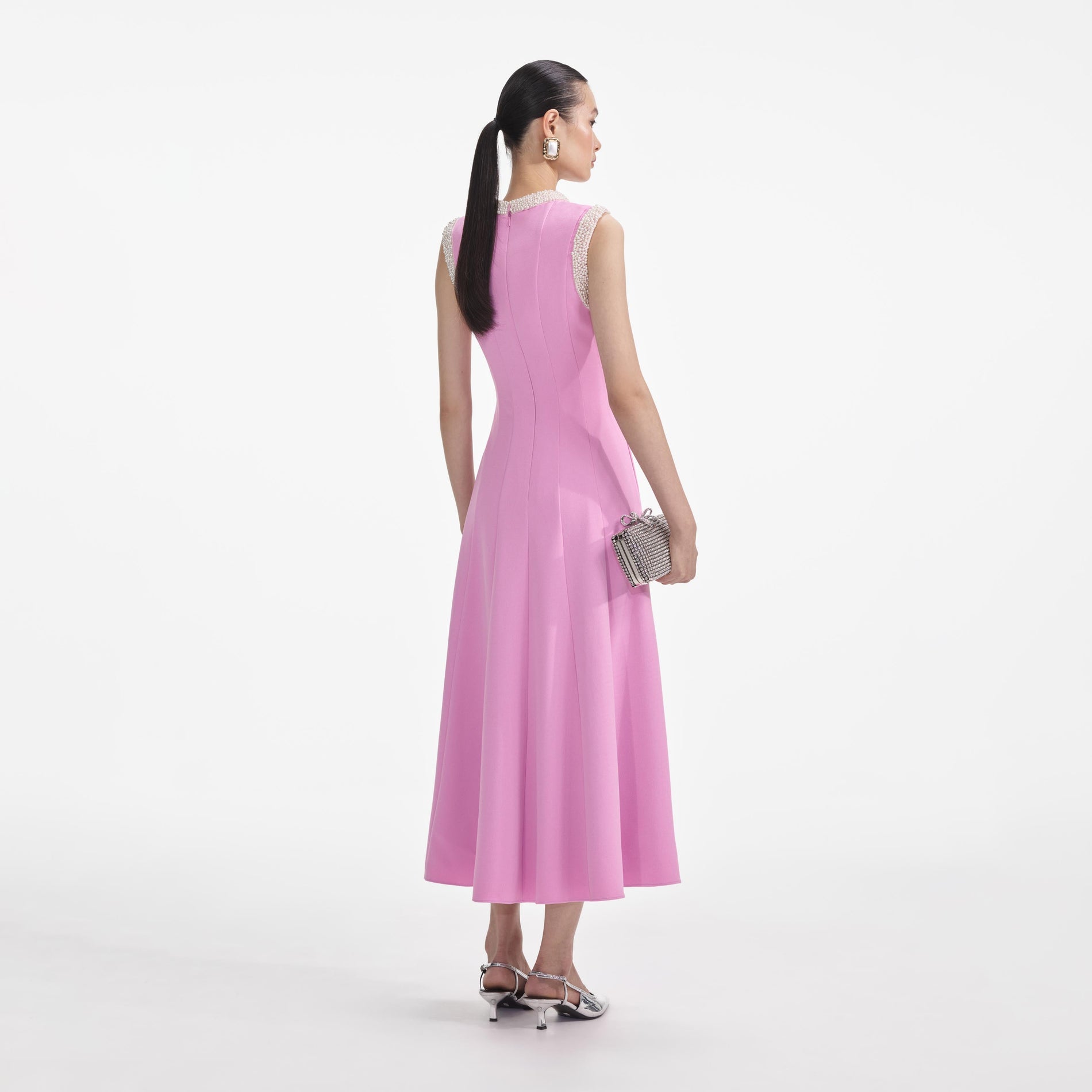 Back view of a woman wearing the Pink Crepe Pearl Trim Midi Dress