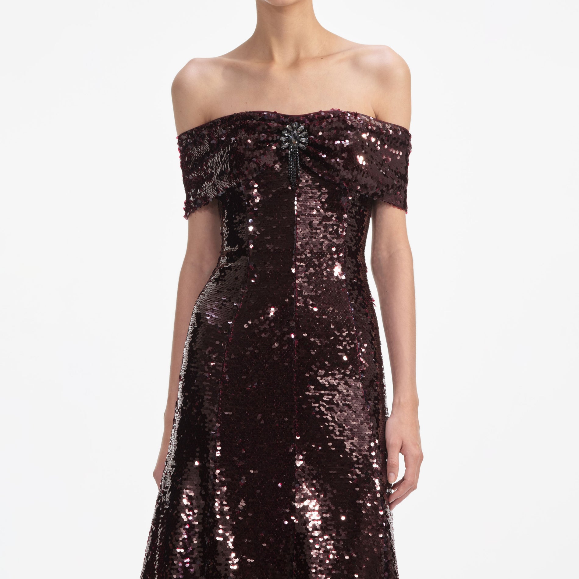 A close up of a woman wearing the Brown Sequin Off Shoulder Midi Dress