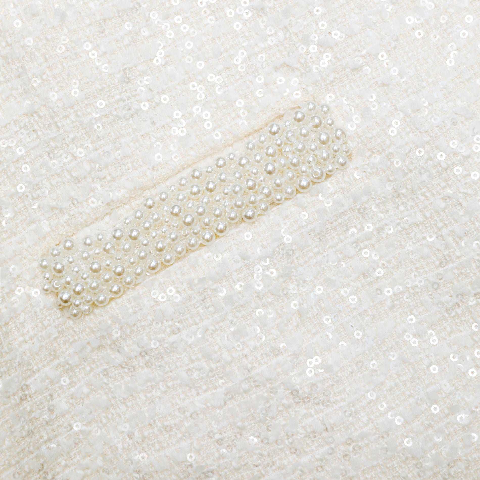 A close up of the fabric for the Cream Boucle Pearl Trim Mini Skirt