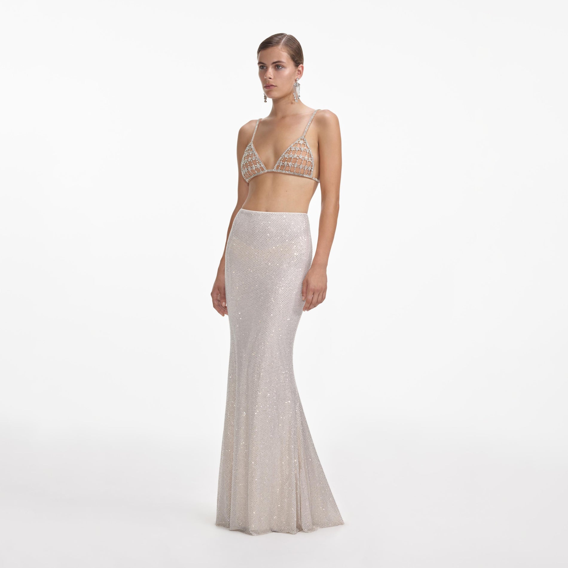 Side view of a woman wearing the Silver Rhinestone Mesh Maxi Skirt