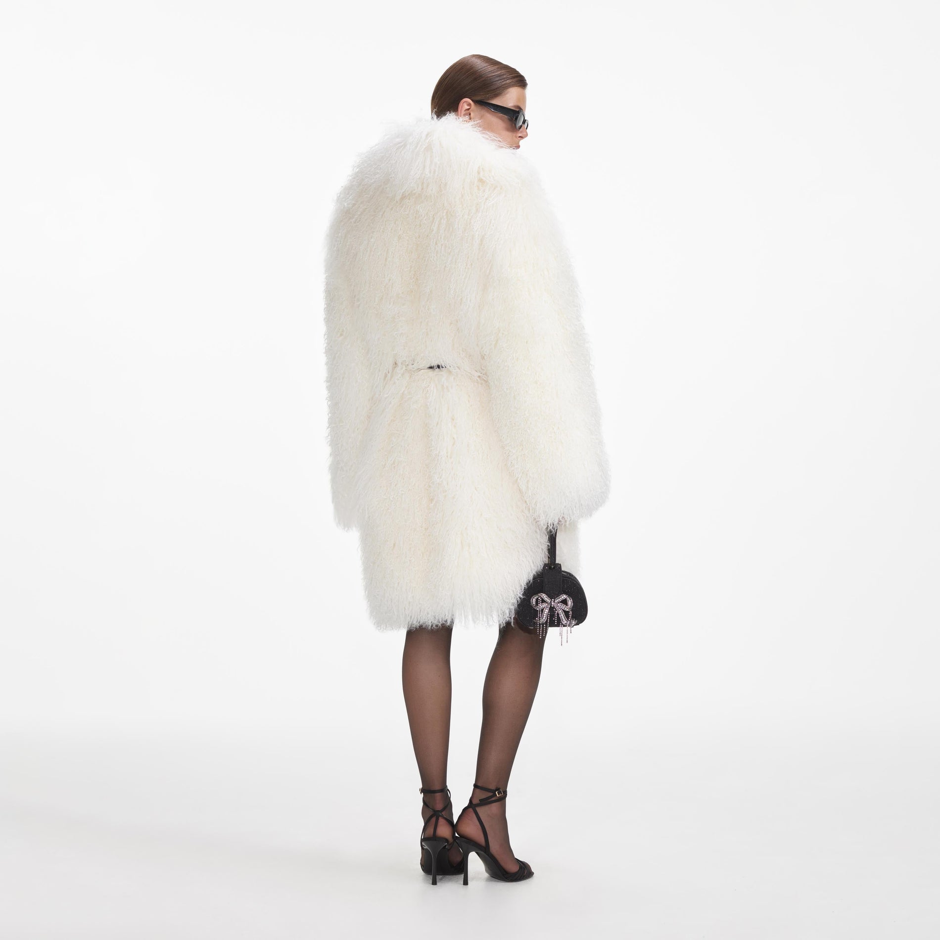 Back view of a woman wearing the Cream Shearling Coat