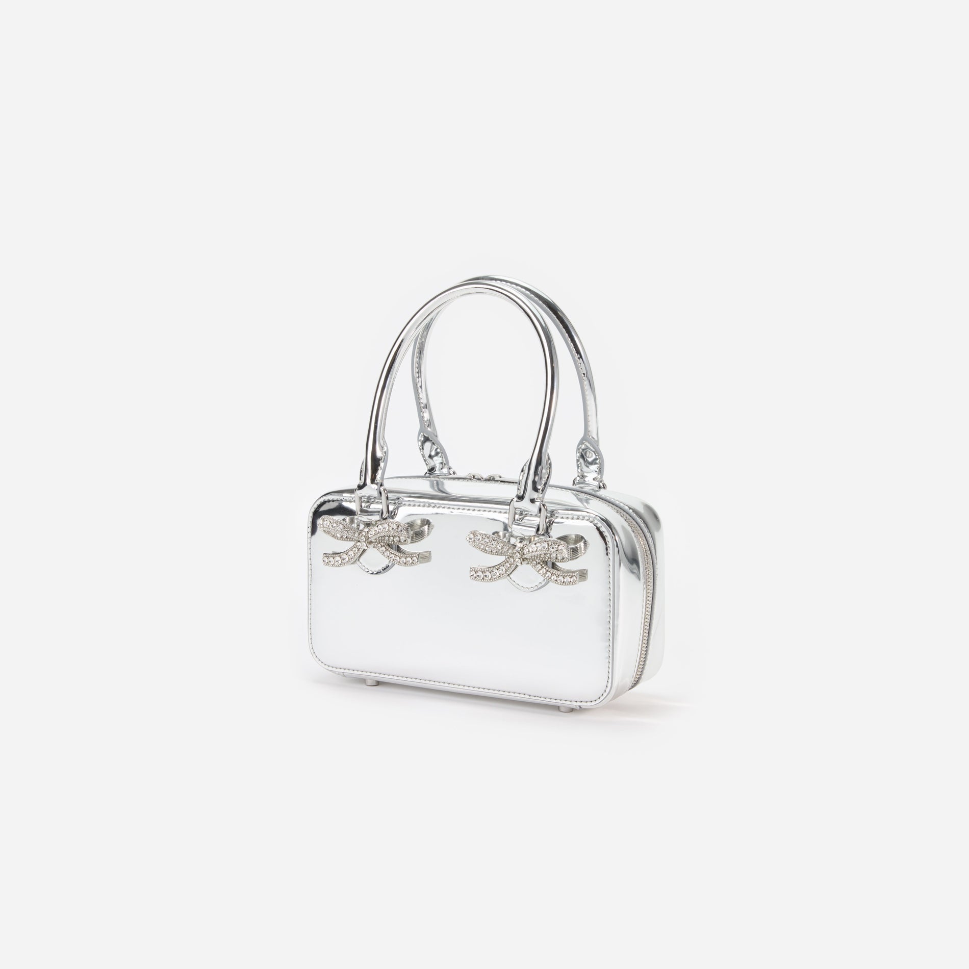 Side view of a woman wearing the Metallic Silver Leather Mini Tote Bag