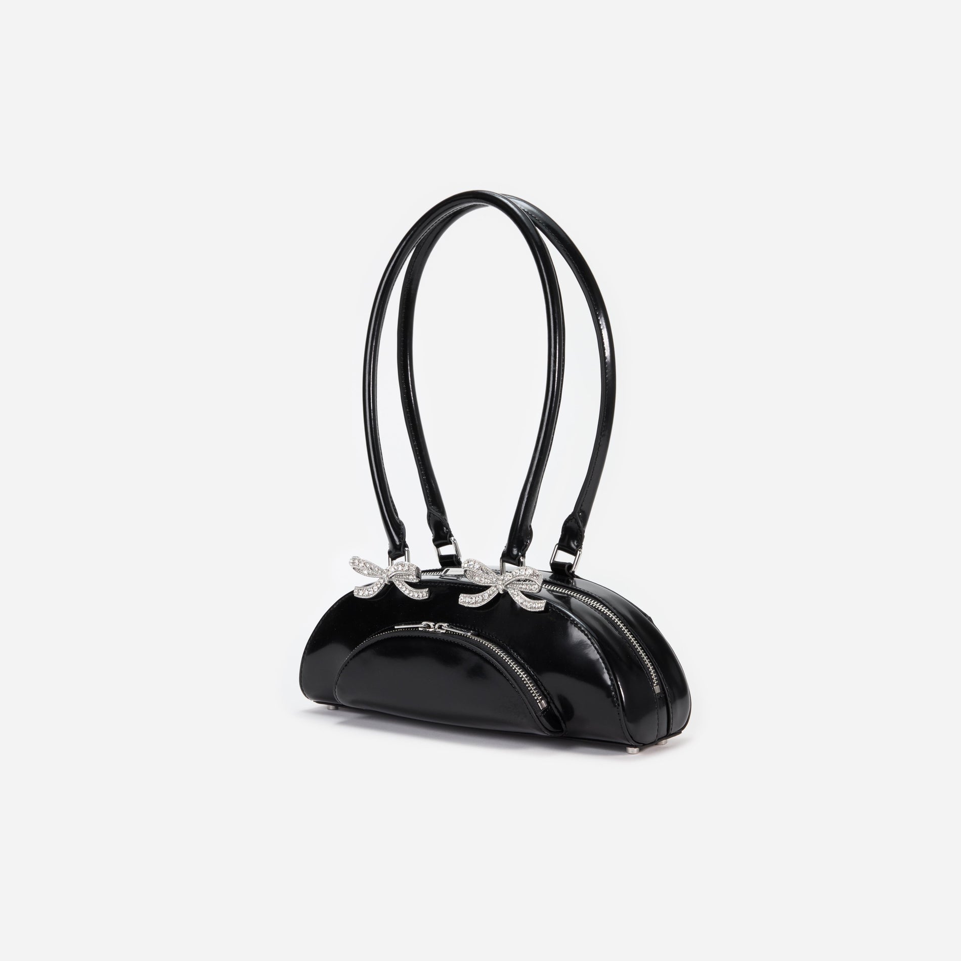 Side view of a woman wearing the Black Leather Curved Shoulder Bag
