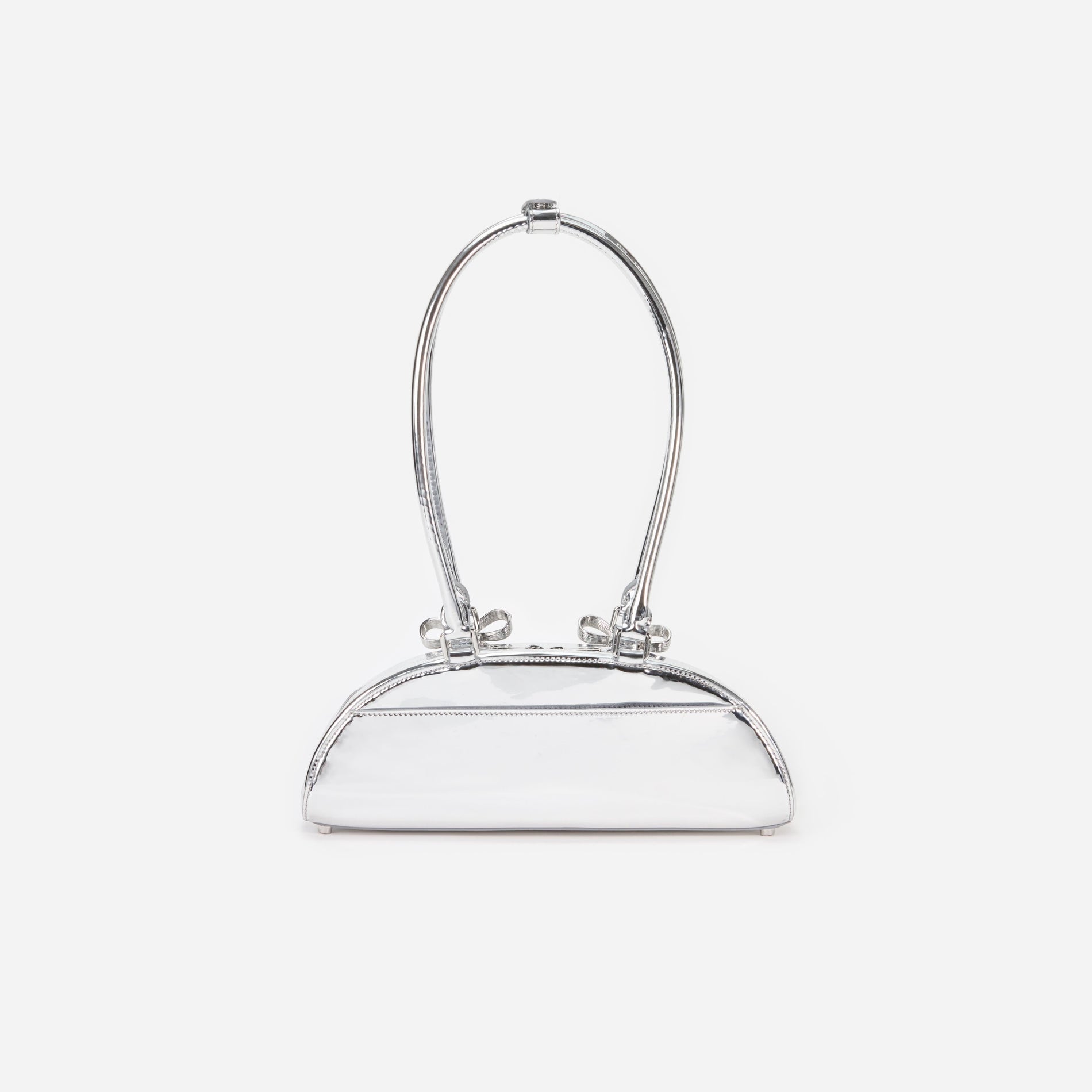 Side view of a woman wearing the Silver Metallic Curved Shoulder Bag