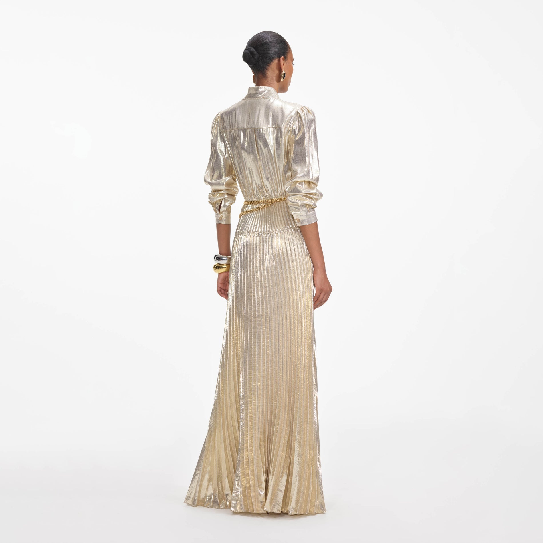 Back view of a woman wearing the Gold Metallic Pussy Bow Maxi Dress