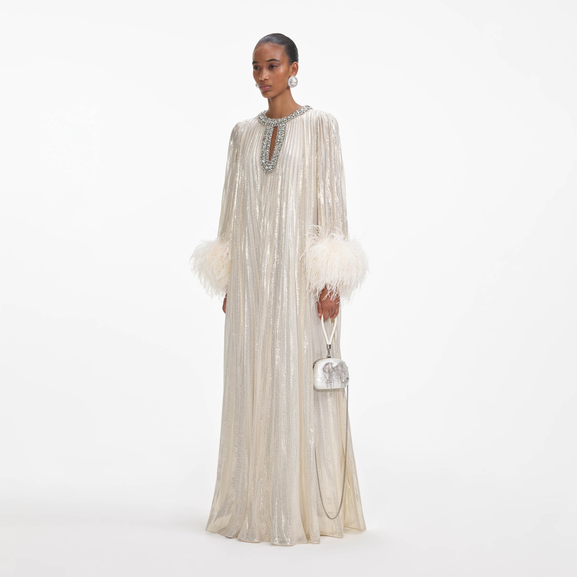 Side view of a woman wearing the Gold Metallic Feather Maxi Dress